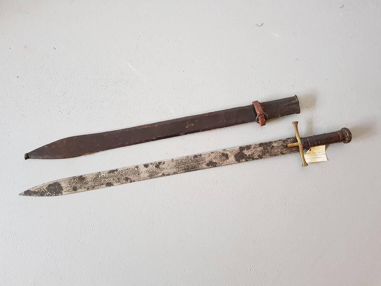 Mid-19th century Kaskara model sword and scabbard of the Hausa tribe Sudan Southern Sahara. It has an etched blade with probably texts from the Koran.

The measurements are,
Depth 4 cm/ 1.5 inch.
Width 11 cm/ 4.3 inch.
Height 78 cm/ 30.7