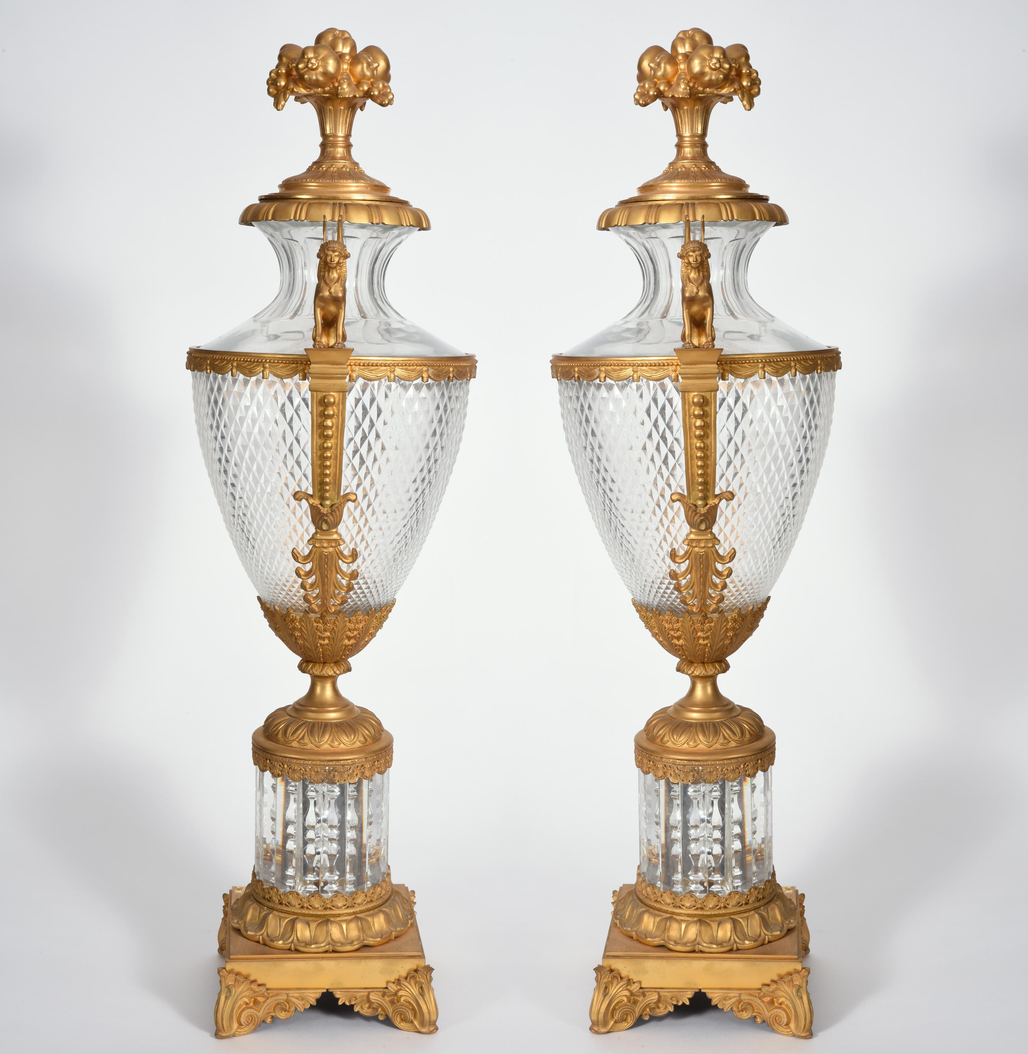 Mid-19th century very large matching pair bronze with cut glass decorative centerpiece urns. Each urn is in excellent antique condition with minor wear consistent to age and use. Each decorative urn measure about 36 inches x 12 inches x 10.5 inches.