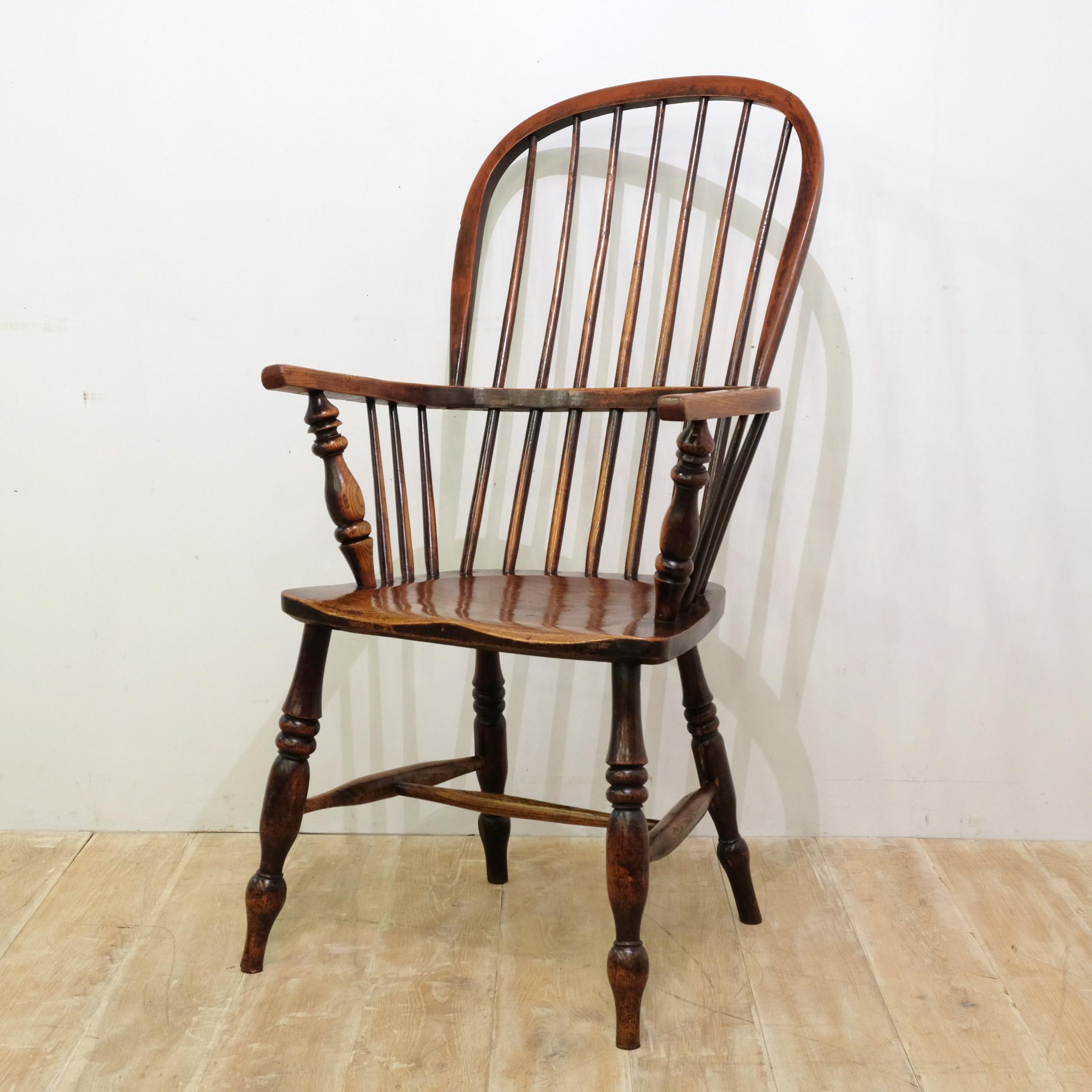 Impressive tall stick back Windsor chair, attributable to the Lincolnshire area, in ash and elm. Lots of the original red stain present and a wonderful grain pattern to the seat. Arm hoop has characterfully misshapen over its 150 or so year life.