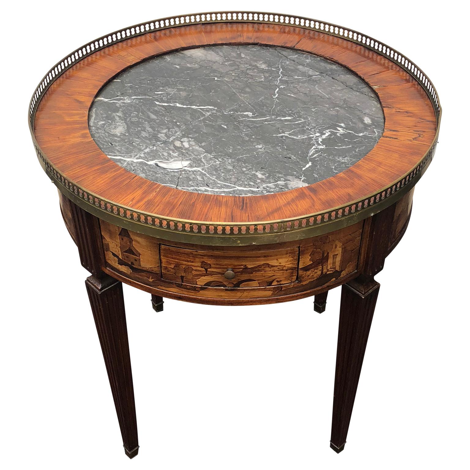 Mid-19th Century Louis XVI French marquetry Bouillotte table.
The amazing French marquetry pattern is represented with architecture and hunting scenes of satin and lemon wood.