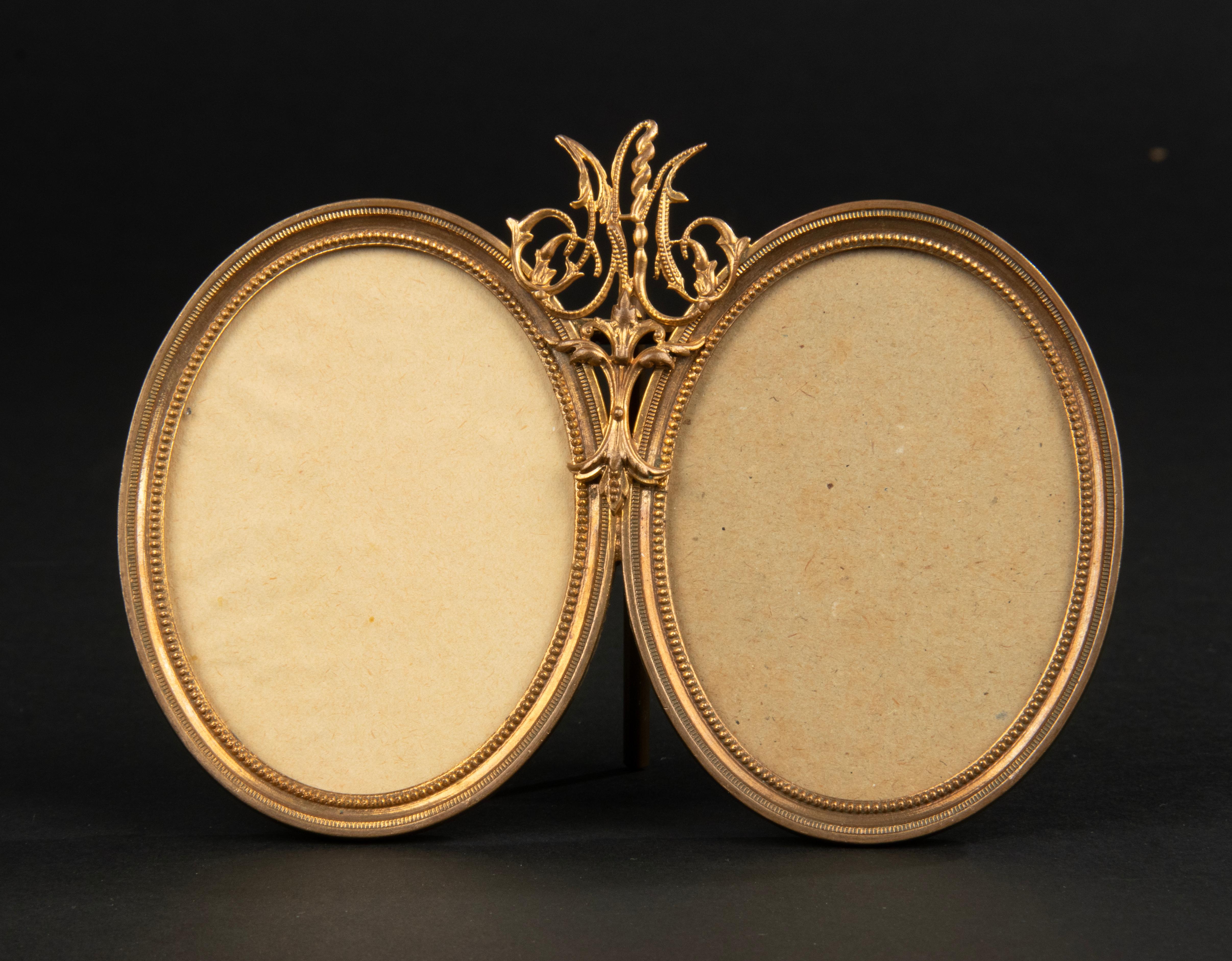 A refined double picture frame made of bronze, with a gilt ormolu finish. Central a finely monogram with the capitals L.M. These where probably the initials of a married couple. Inside the beaded rim are glass covers. Made in France, late Napoleon