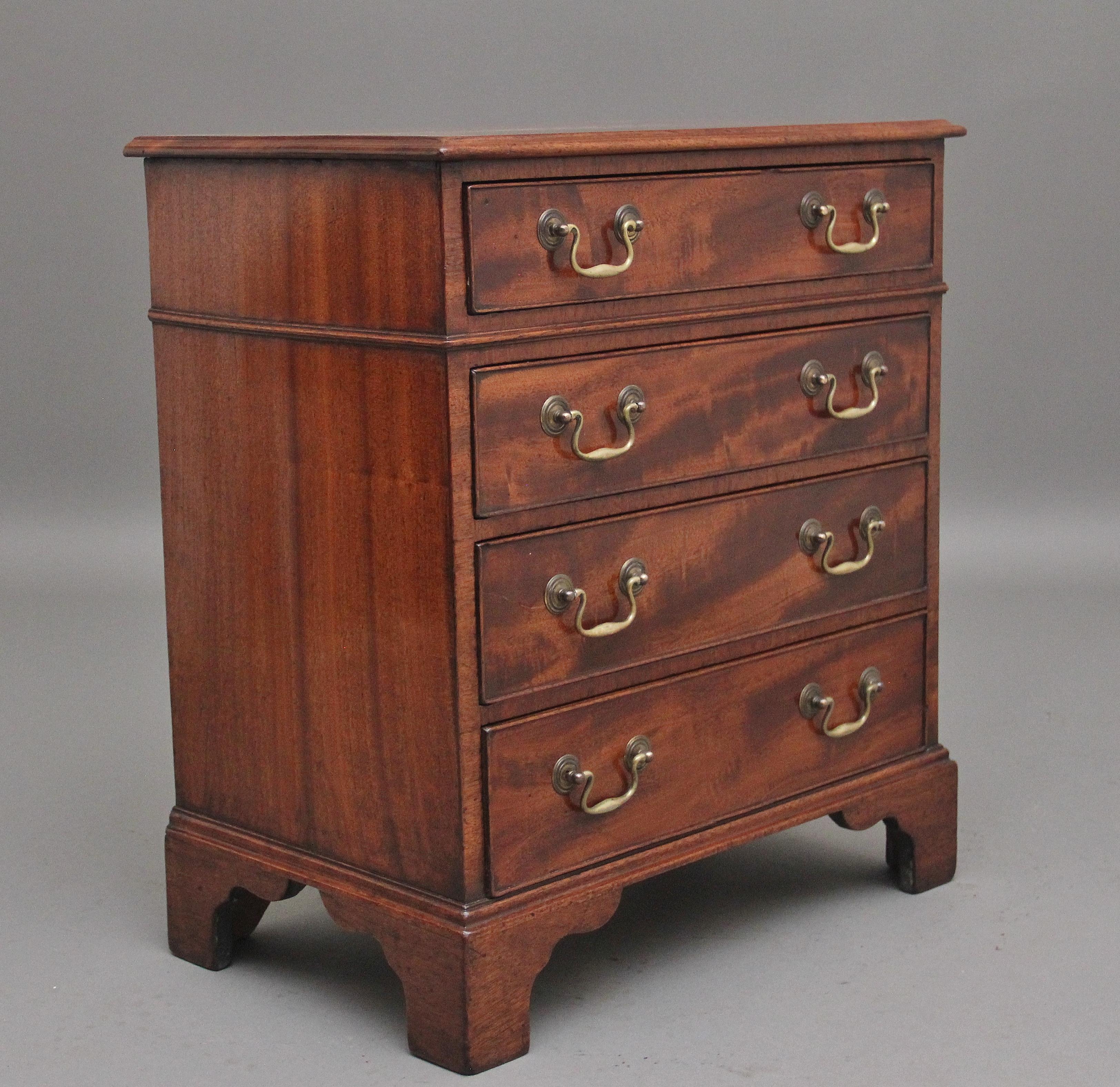 Mid 19th Century mahogany bedside chest of drawers, having a lovely figured moulded edge top above four long graduated oak lined drawers with the original brass swan neck handles, supported on shaped bracket feet.  Circa 1840.