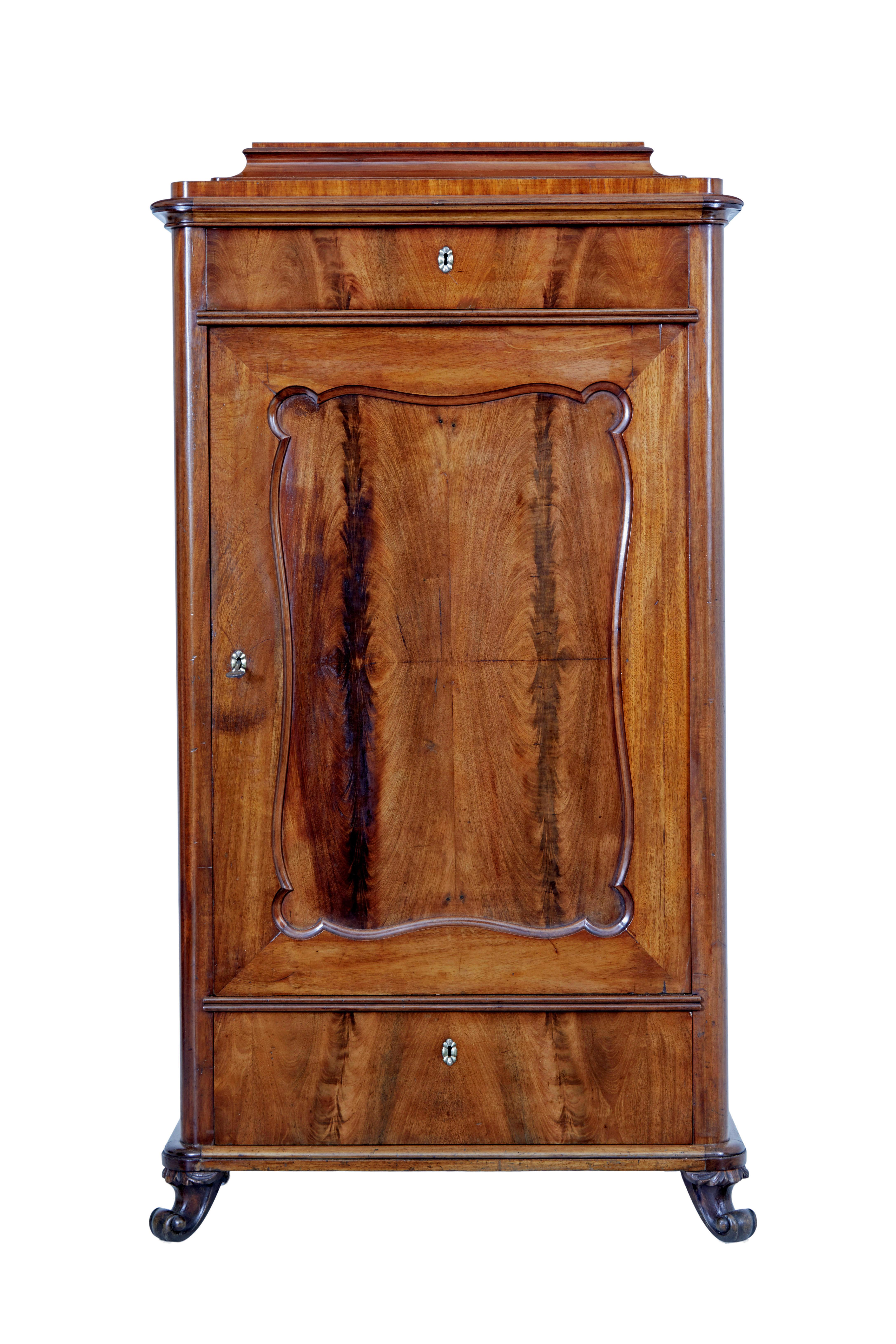 Mid 19th century mahogany caddy top cupboard circa 1860.

Elegant flame mahogany 1 piece cupboard.    Layered caddy top which can be removed, single drawer below the top surface.  Main door veneered in flame mahogany in a cartouche shaped panel,