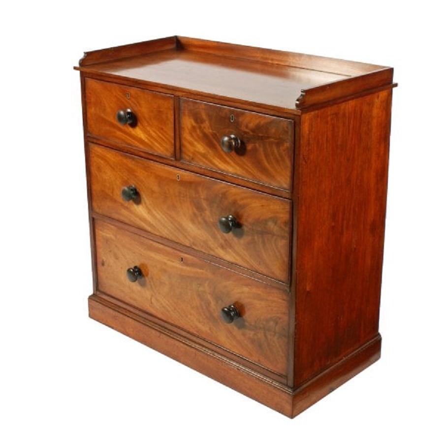 A middle of the 19th century Victorian mahogany chest of four drawers.


The chest has a gallery back to three sides and has a plinth base.


The chest is a very neat size with two short drawers over two long drawers that have a cock beaded