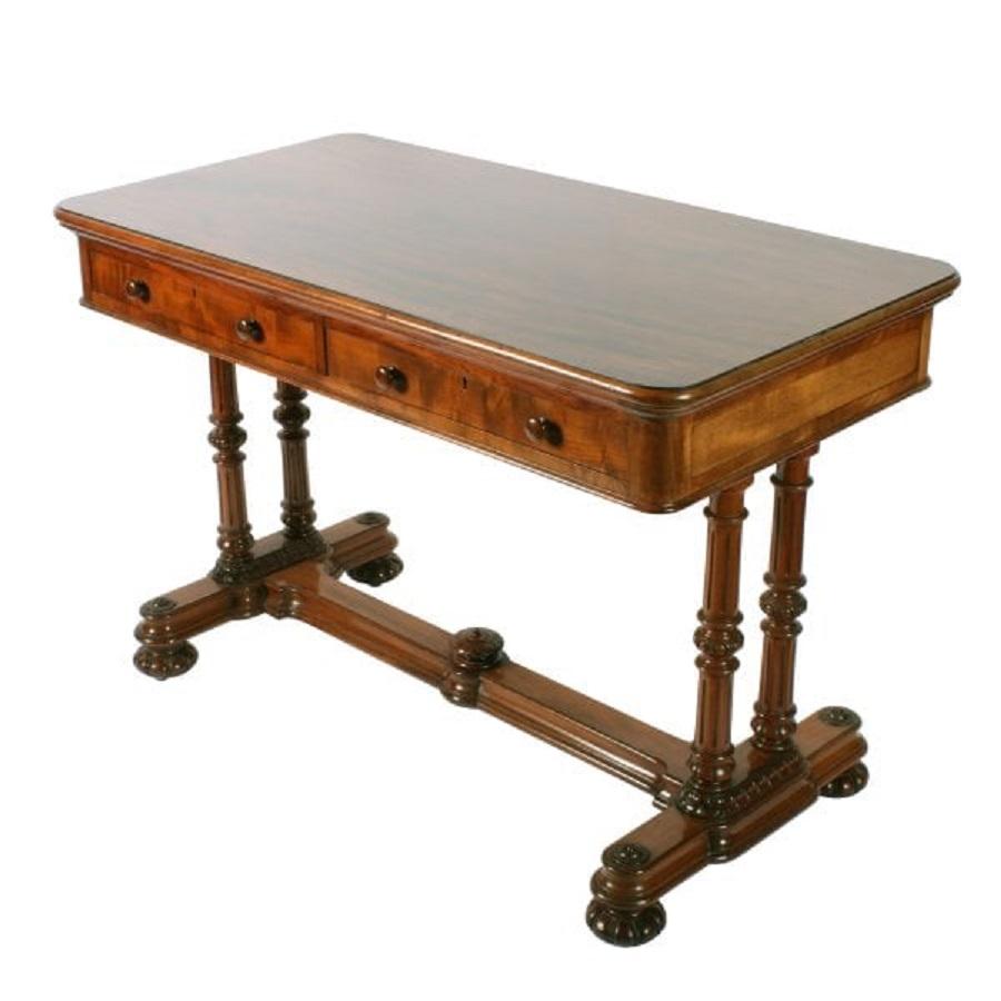 A mid 19th century exhibition quality mahogany two drawer library table.

The table top is oblong with rounded corners and edges, two drawers to the front and two dummy drawers to the reverse.

The drawers are cedar wood lined and have turned