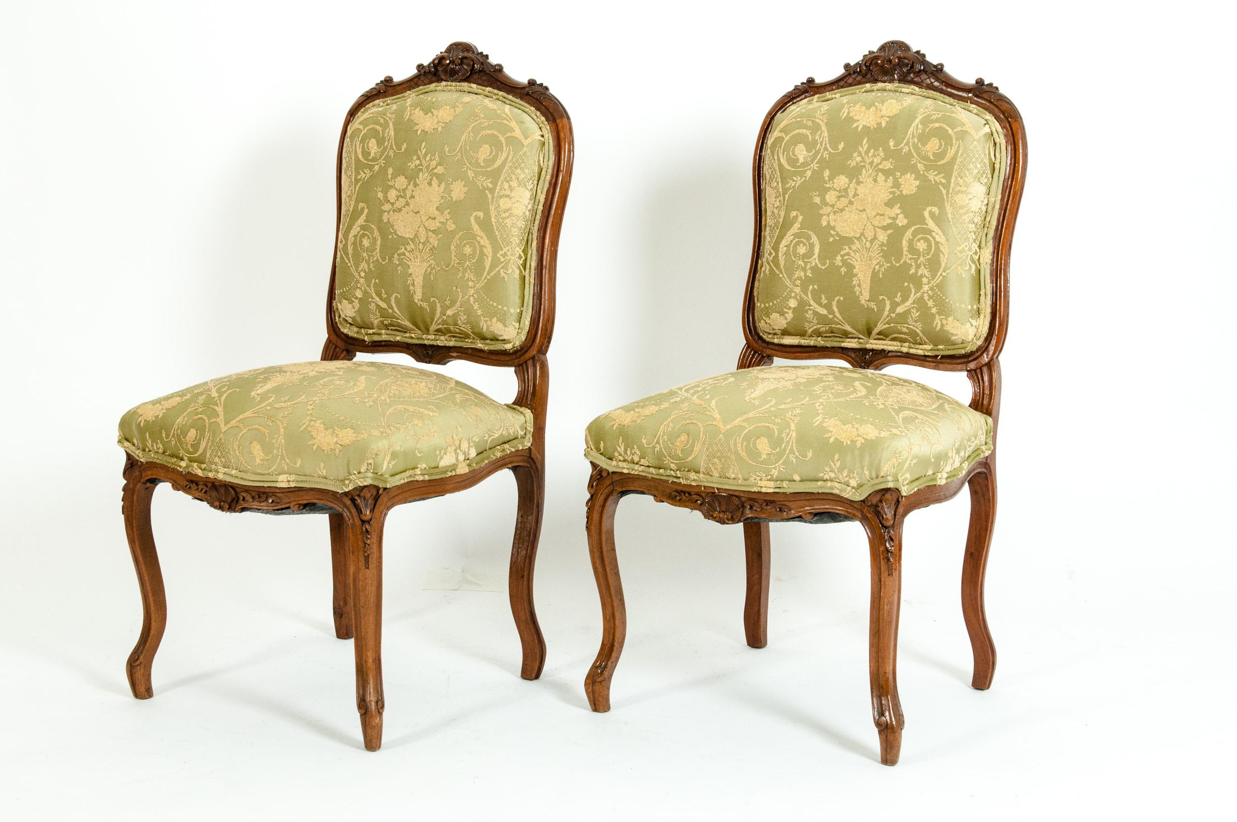Mid-19th century mahogany wood frame pair side chairs. Each chair is very sturdy and in good antique condition with age / use appropriate wear. The upholstery is very immaculate. Each chair stand about 38 inches H x 20 inches wide x 17 inches deep.