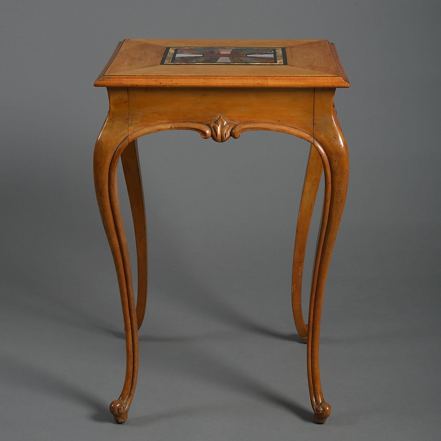 The rectangular top inset with a pietra-dura panel of specimen marbles bordered with maple-wood and raised on carved cabriole leg.