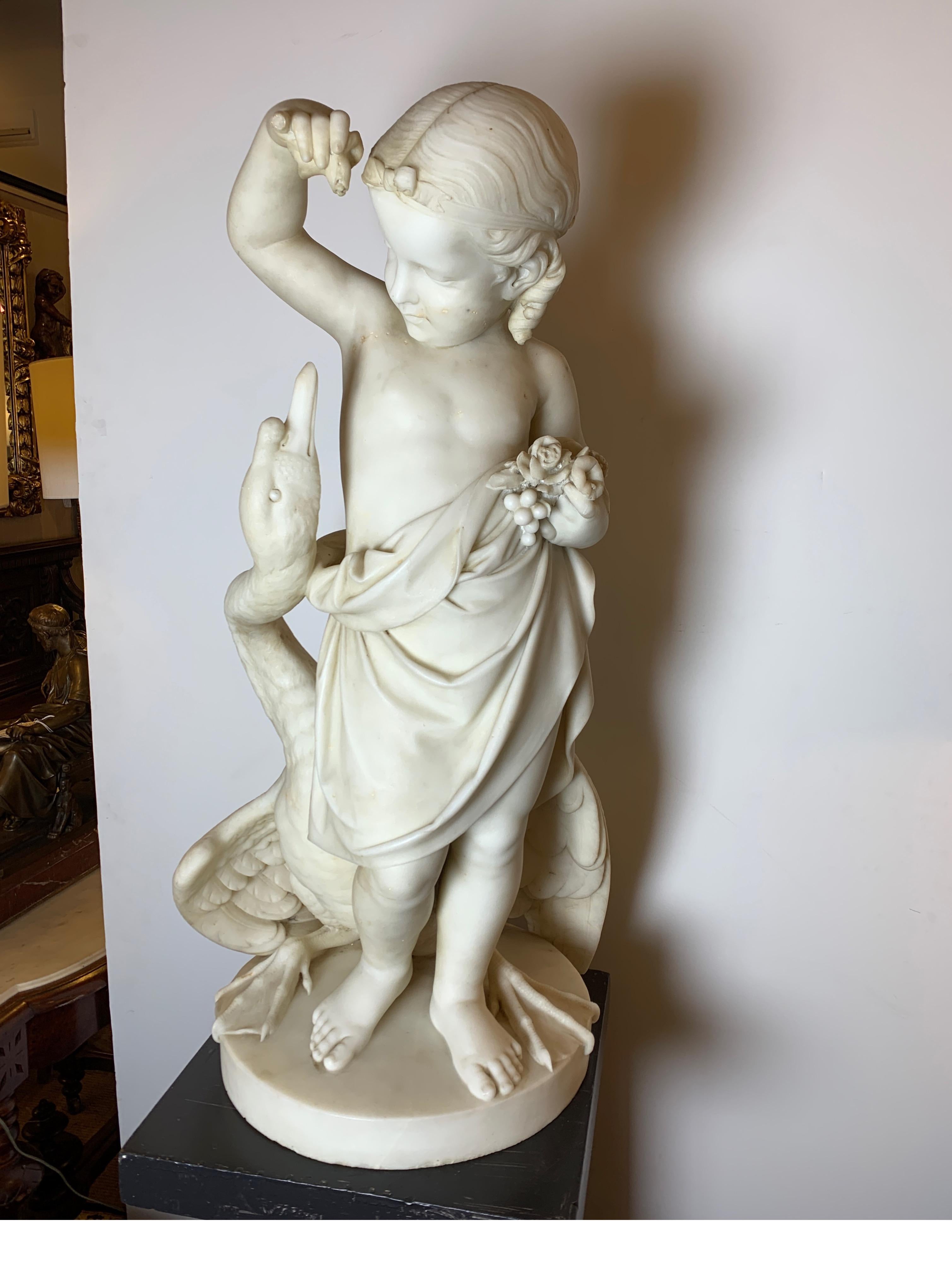 Hand carved Italian marble sculpture of a young Leda and the Swan circa 1850. The slid marble sculpture of a standing young girl in draped costume with the swan along side on a circular base. Overall good condition with the tip of one finger missing