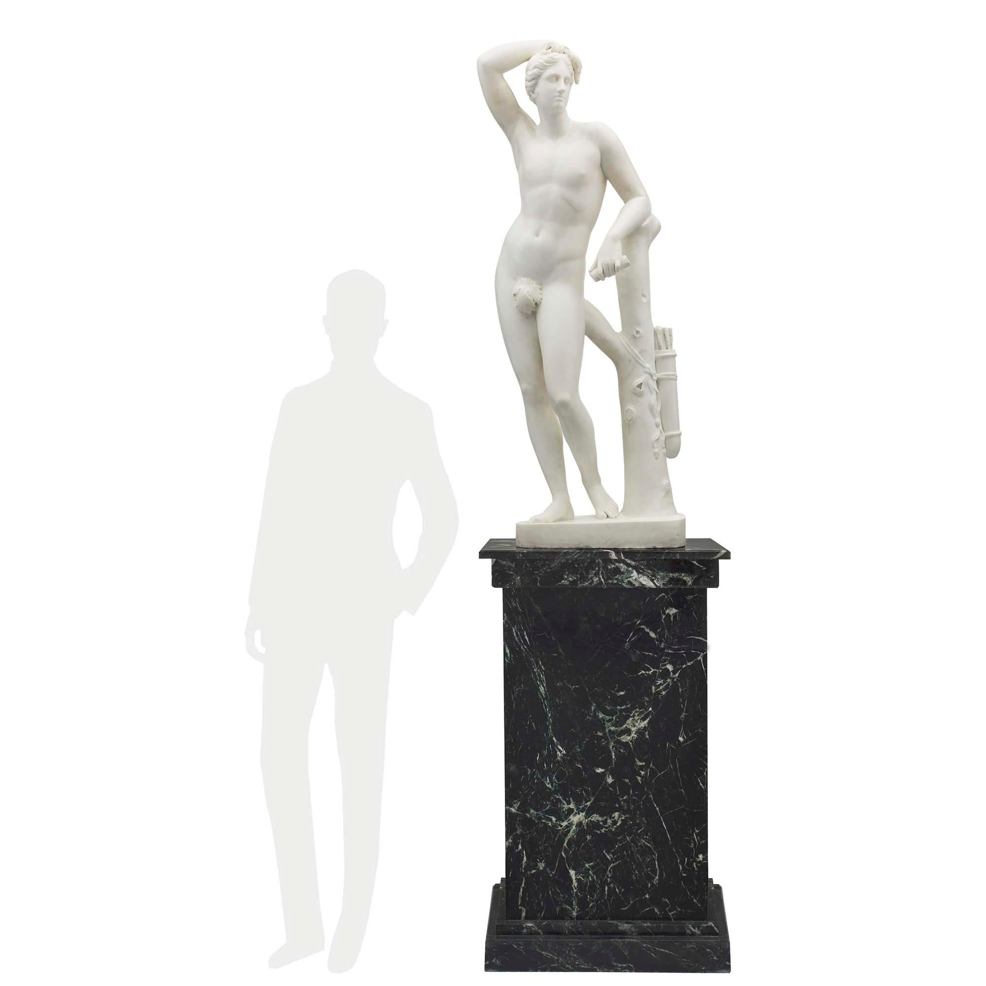 A striking Italian mid-19th century neoclassical white Carrara marble statue of Apollo signed V Livi Ejegui Carrara, 1845. The Statue is raised by an oval base with a tree truck where his quiver is hanging, tied by a finely sculpted bow. The