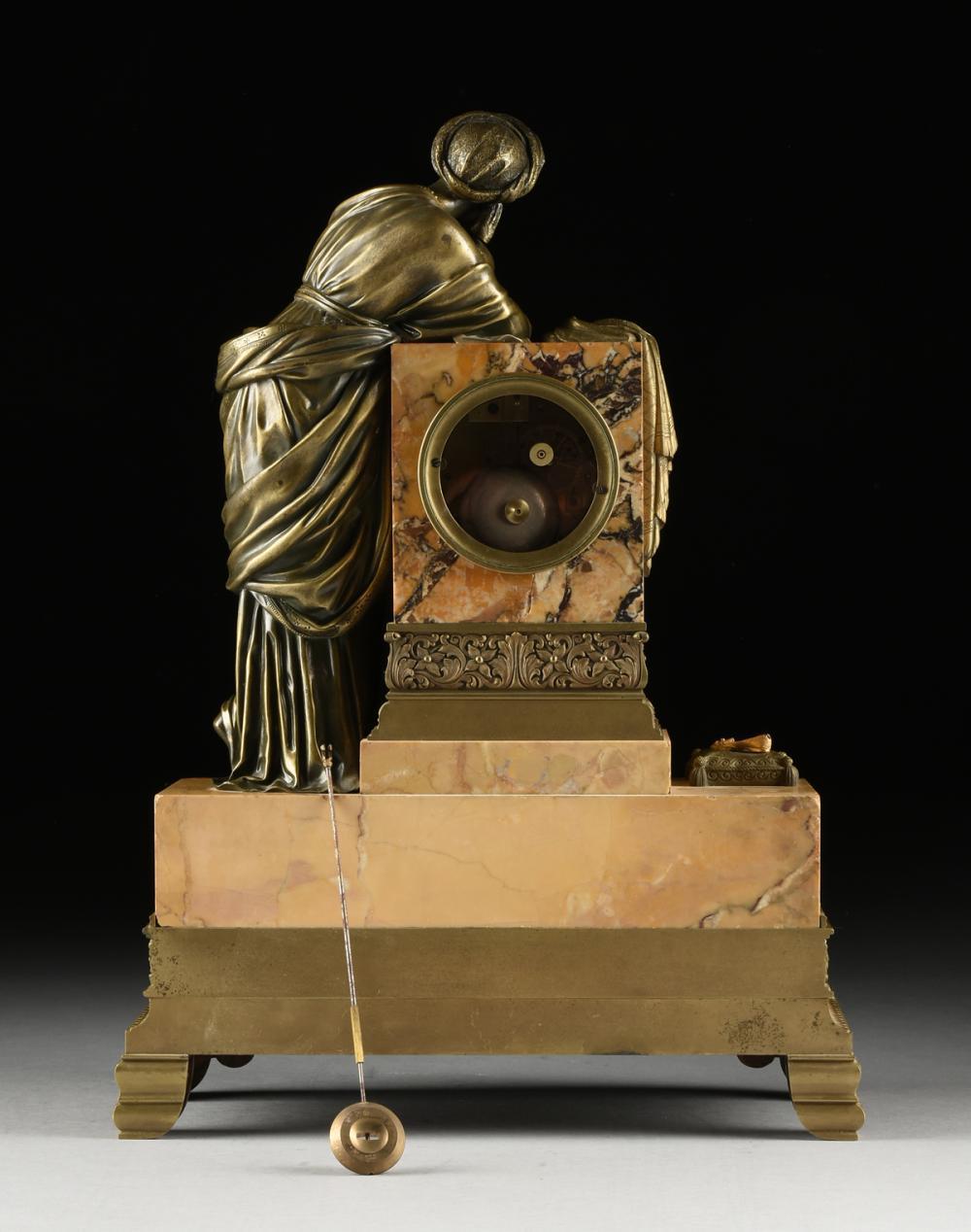 Mid 19th Century Orientalist Bronze Mounted Siena Marble Mantle Clock, France.
The classically robed maiden wearing an intricately detailed turban and holding a pen, while leaning on a block form pedestal draped with a shawl behind two lidded