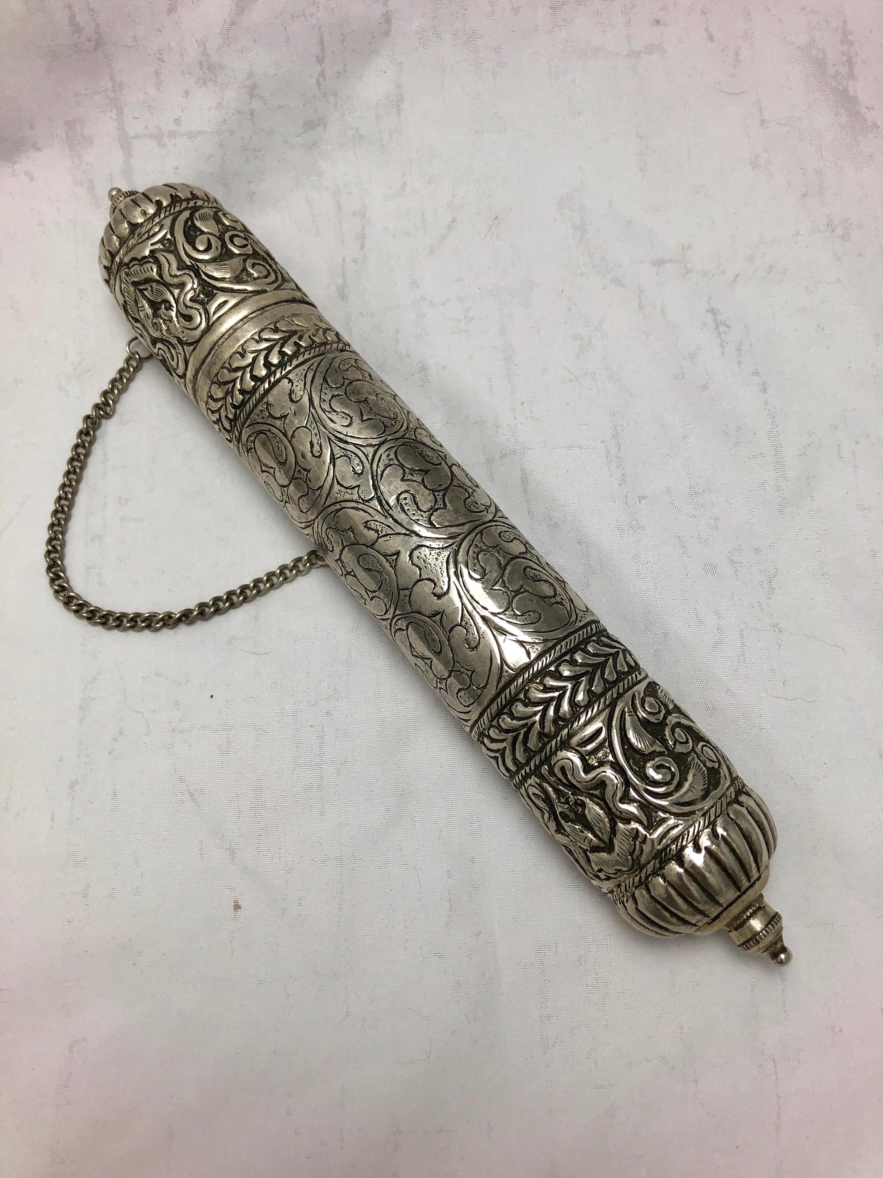 A beautiful, early to mid-19th century silver scroll holder in very good condition. 

The scroll is profusely decorated with engraved and repousse designs, with foliage and flowers. It opens at one end and would contain a religious prayer, message
