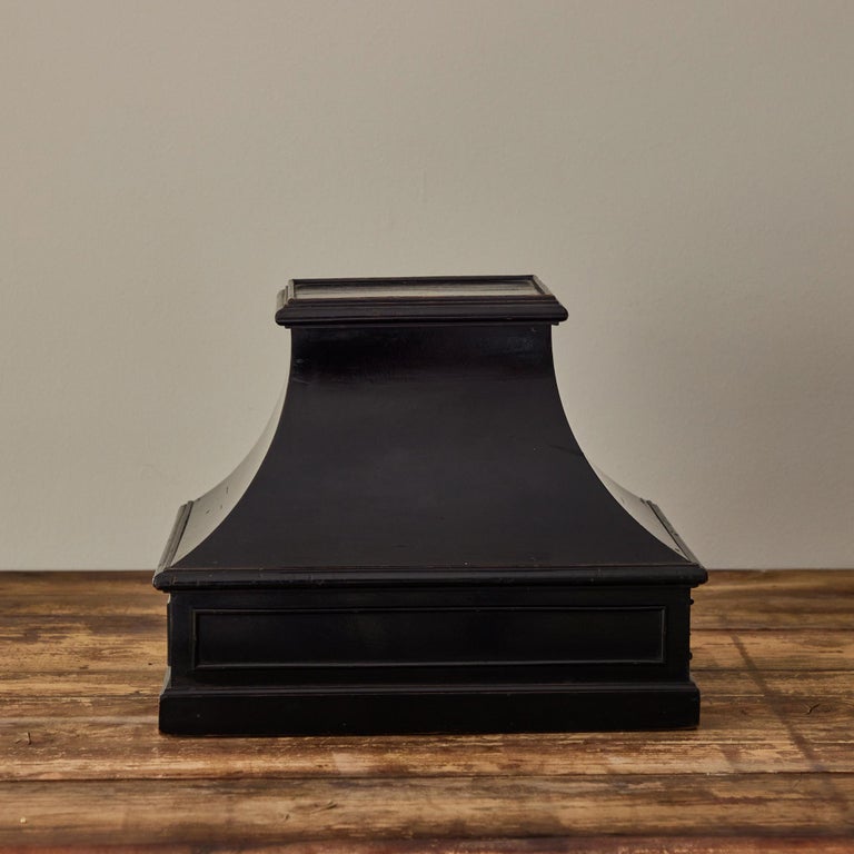 Carved and painted black wooden table plinth from late 19th-century France.  With its strong lines and subtle architectural flourishes, the piece works both as a decorative object, and as a stand for a sculpture or vase.

France, circa