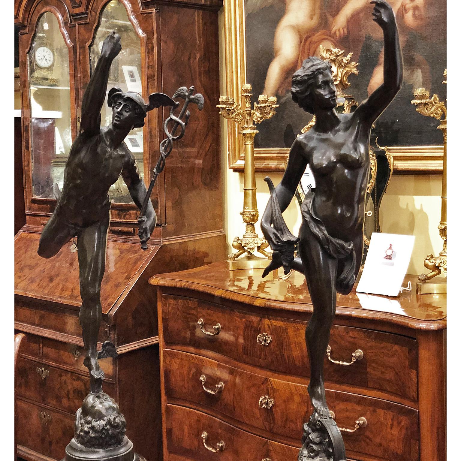 Pair of bronze table sculptures on circular pedestal in black marble. The first sculpture depicts the God Mercury (Hermes) and the second the Goddess of Fortune (Tyche), both figures are about to fly. The cylindrical marble base is worked with a low