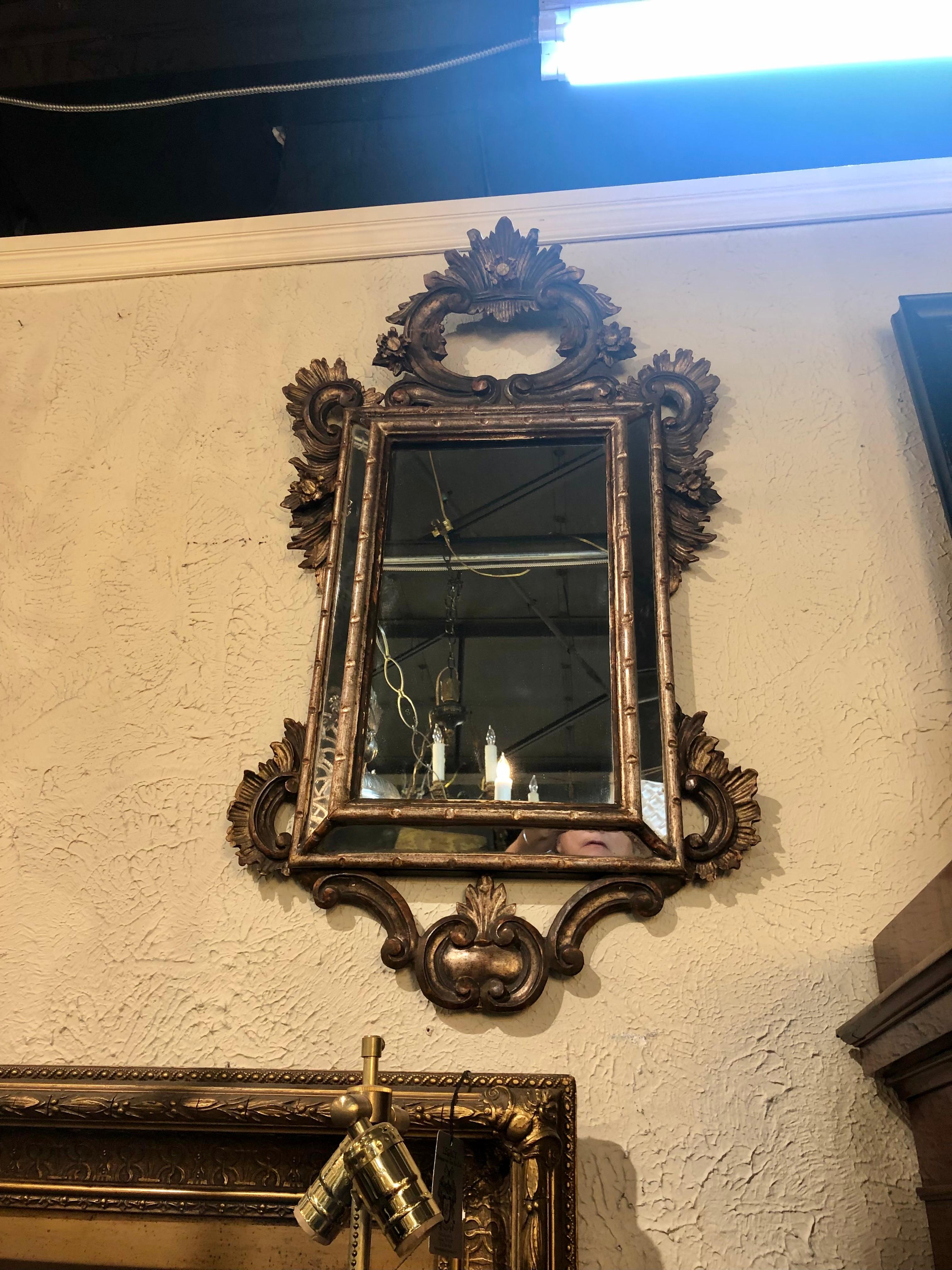 Phenomenal pair of mid-19th century Italian cushion mirrors. The reticulated frames feature superb open-work carvings of leaf sprays and scrolls with leaf feathered trim,

circa 1850.