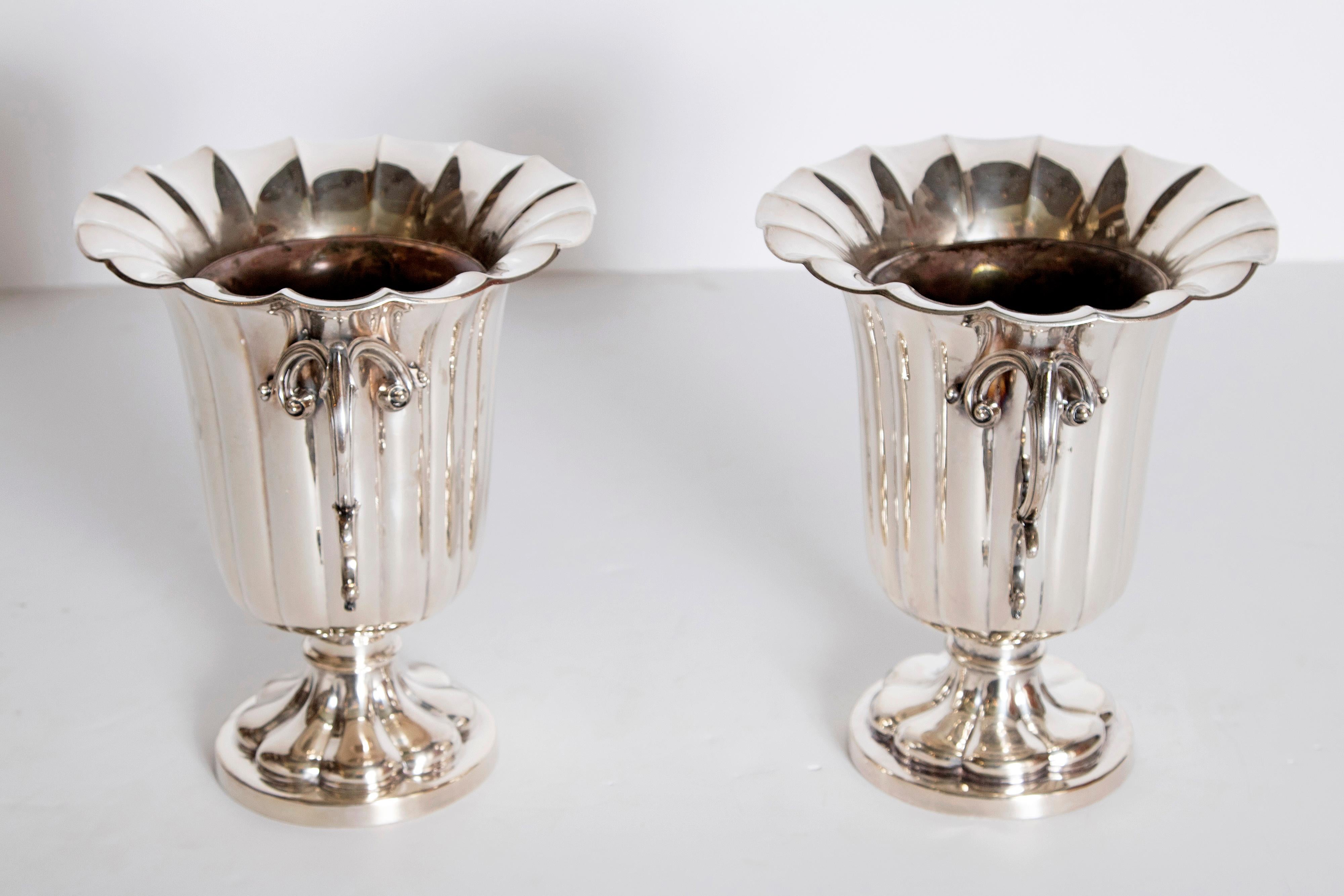 A pair of silver plate ice vases with liners. Ribbed urn form body with flaring ruffled rim openwork and acanthus handles. Sitting on a flared circular foot. Marks on base rim. Elkington & Co., England, circa 1850.