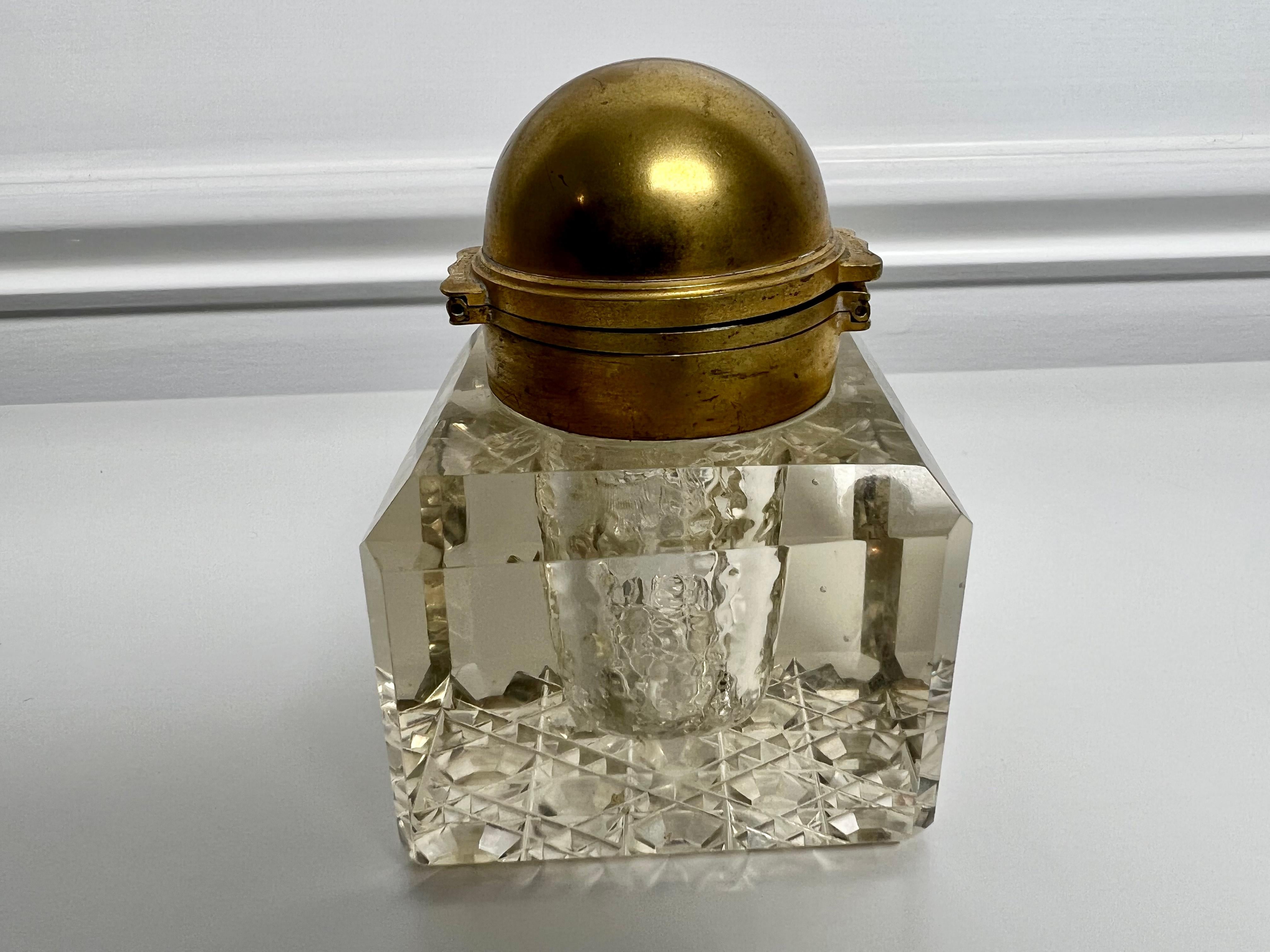 Mid 19th century partner's inkwell with a double opening brass top and a cut crystal daisy bottom. This is a great piece you don't see too many partner's desk inkwells and in good condition. The top is hinged on both sides which lets you open it