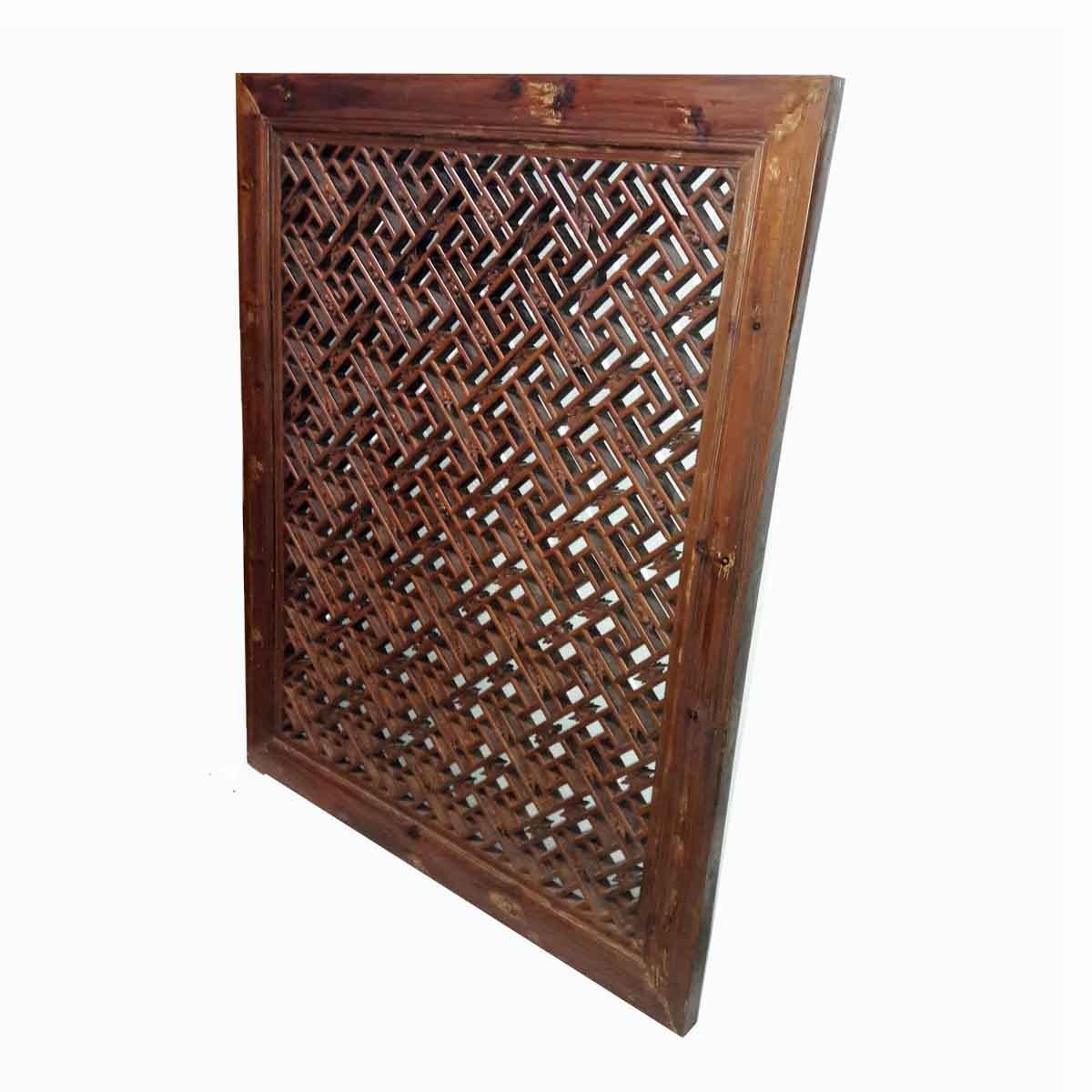 An antique window screen from Sianxi, China, Mid-19th Century. 
Solid peachwood in dark finish with intricate floral hand-carvings in diagonal pattern

Measures : 38 inches wide, 46.5 inches high, 2 inches deep.