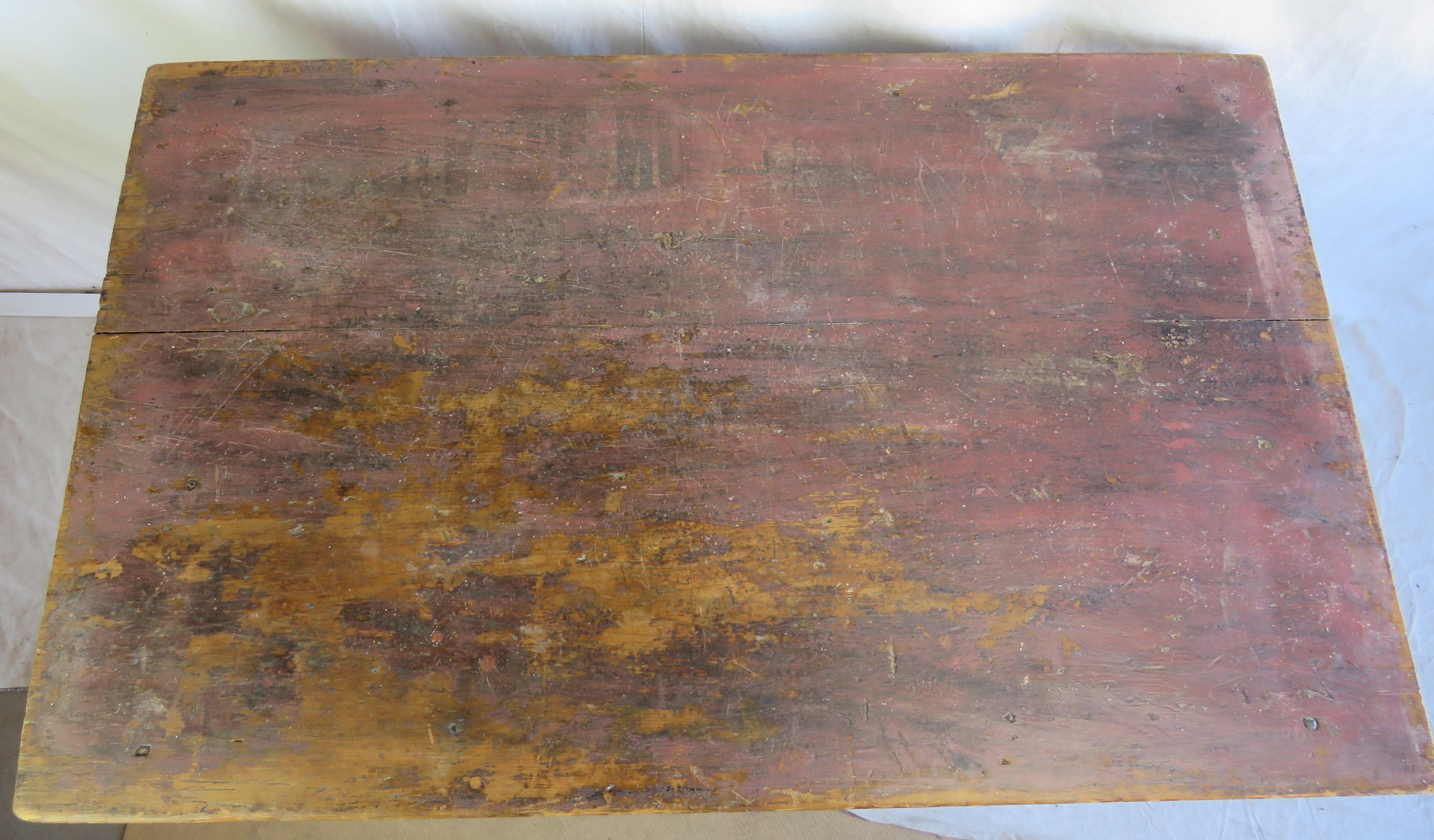 Mid-19th century side table in original red paint, two board top, and tapered legs. Great surface.