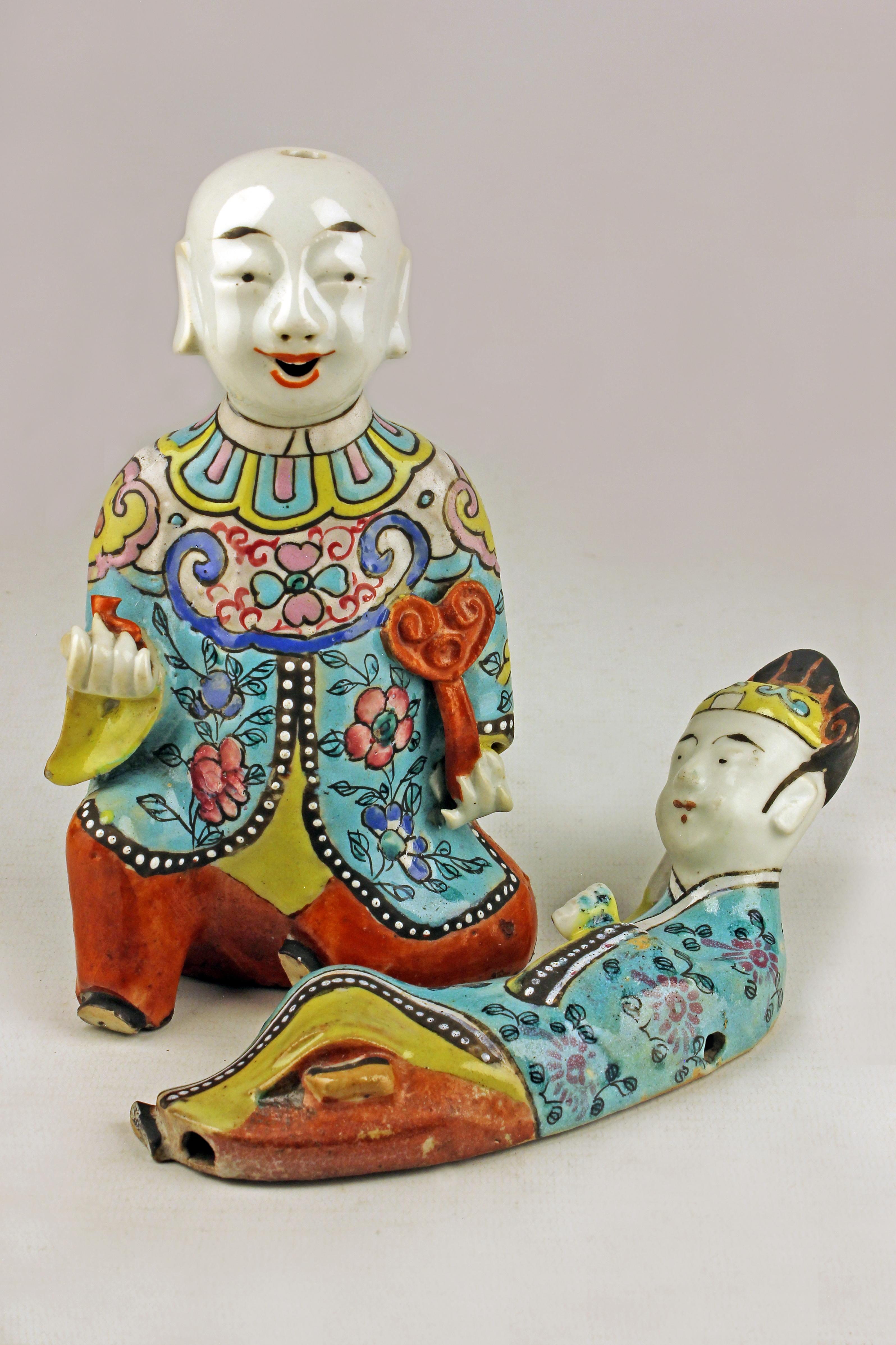 Pair of Mid-19th century/Qing dinasty enameled chinese porcelain figurines depicting a laughing boy kneeling and another lying down 

By: unknown
Material: porcelain, ceramic, enamel, paint
Technique: pressed, molded, glazed, polished, enameled,