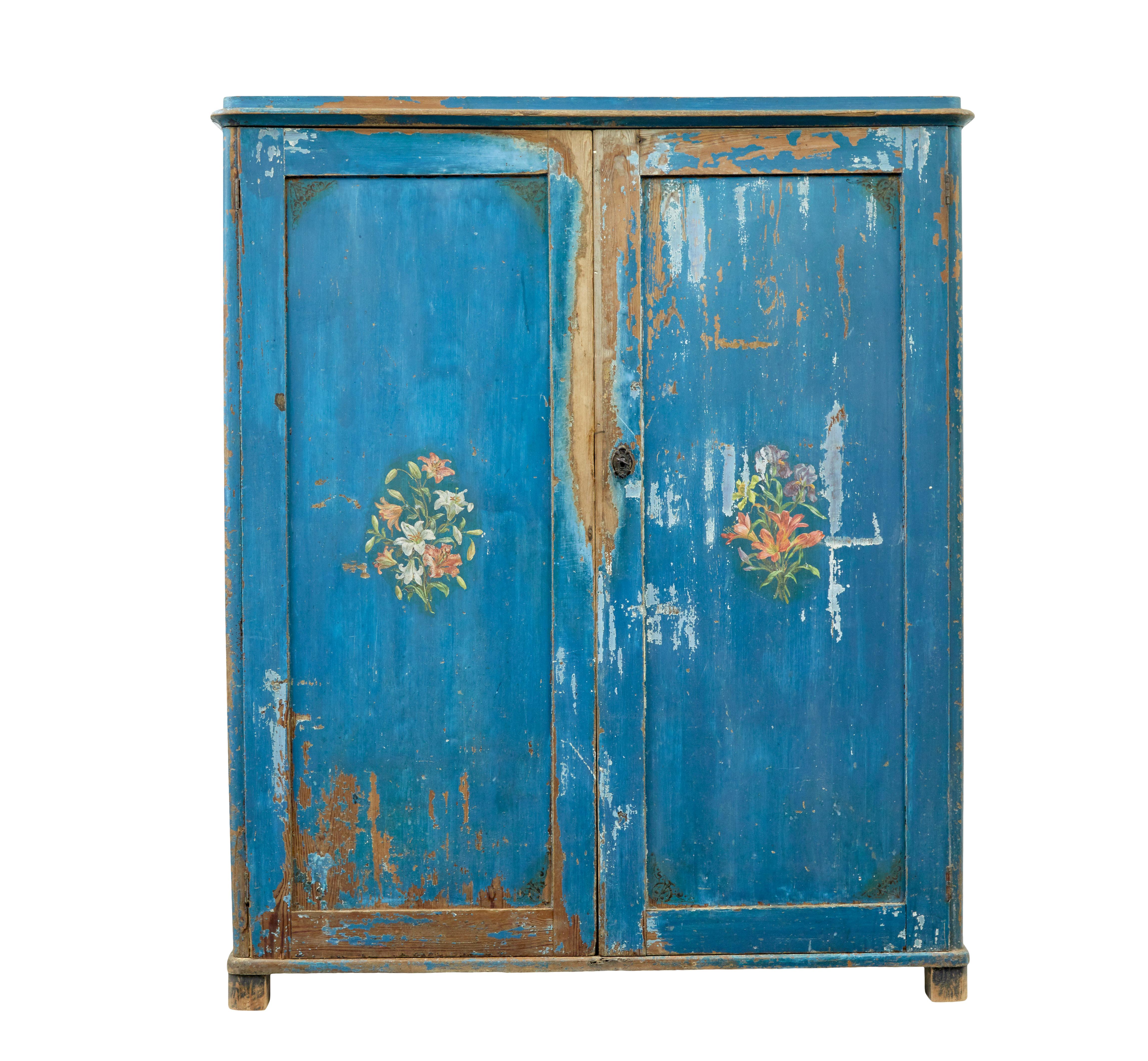 Mid 19th century rustic Scandinavian painted cupboard circa 1860.

We are pleased to offer this rustic Swedish kitchen cupboard in original condition.

Traditional original Swedish blue paint, embellished with hand painted florals to each door