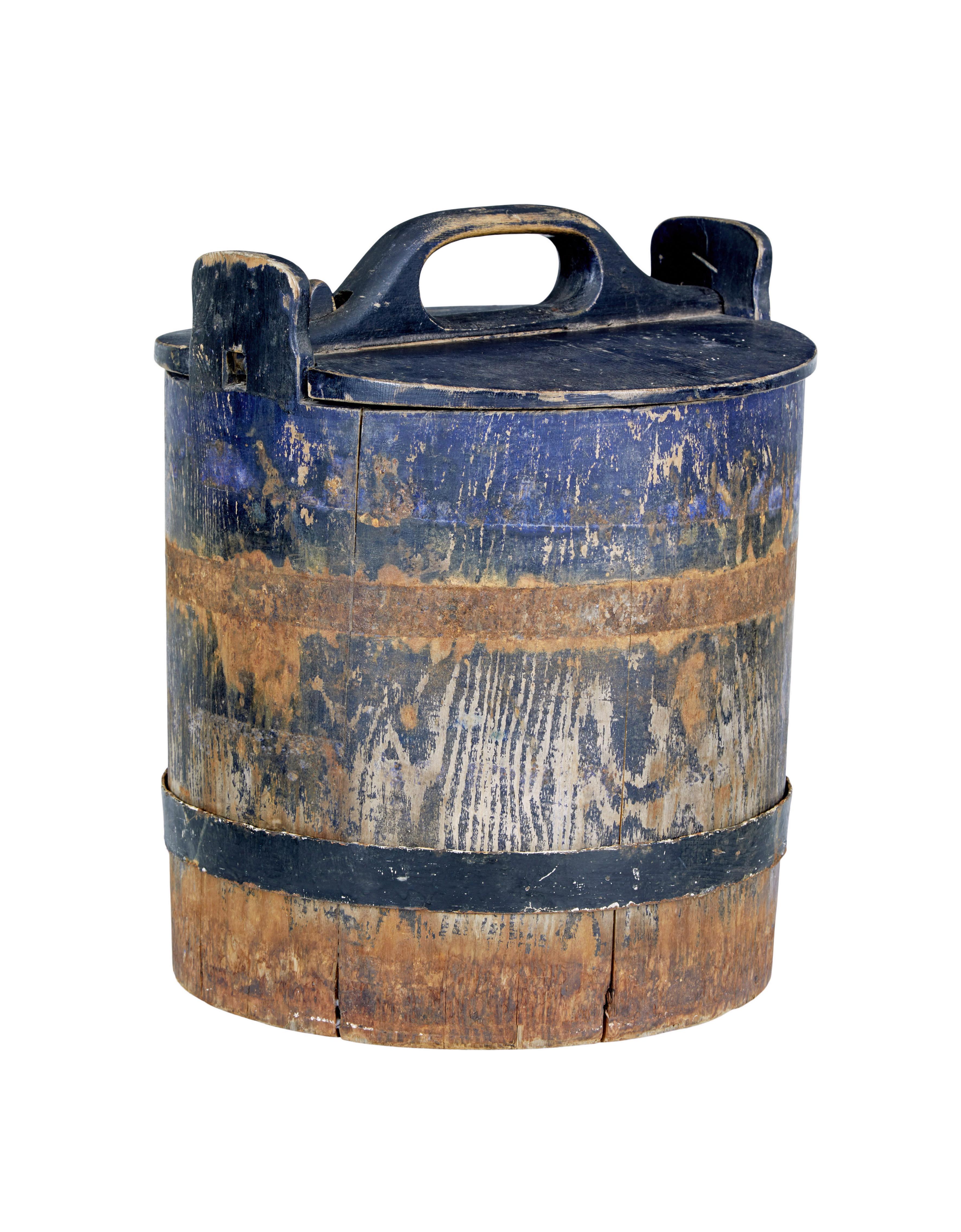 Mid 19th century rustic Swedish pine storage container circa 1860.

Very nice rare item to find intact.  Made from pine with original bold blue paint, 1 original metal support hoop the other is no longer present.   Lid still present and