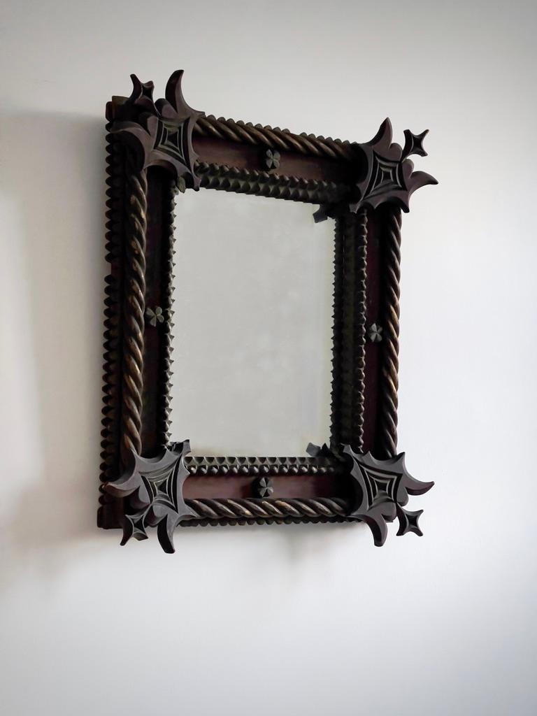 This mid-19th century Scandinavian mirror is a finely handcrafted example of Gothic Revival design, reflecting the romantic historicism that swept through Northern Europe during the period. Executed in solid hardwood, the frame retains its original