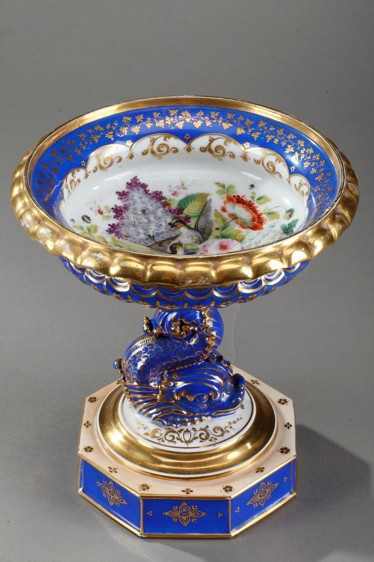 porzellan-Servierplatte aus dem 19. Jahrhundert, exquisit handbemalt in Polychromie mit vergoldeten Akzenten. Es ist mit Blumen, Blättern und Rinceau auf weißem und blauem Hintergrund verziert. Die Servierschale ist mit einer Vielzahl von