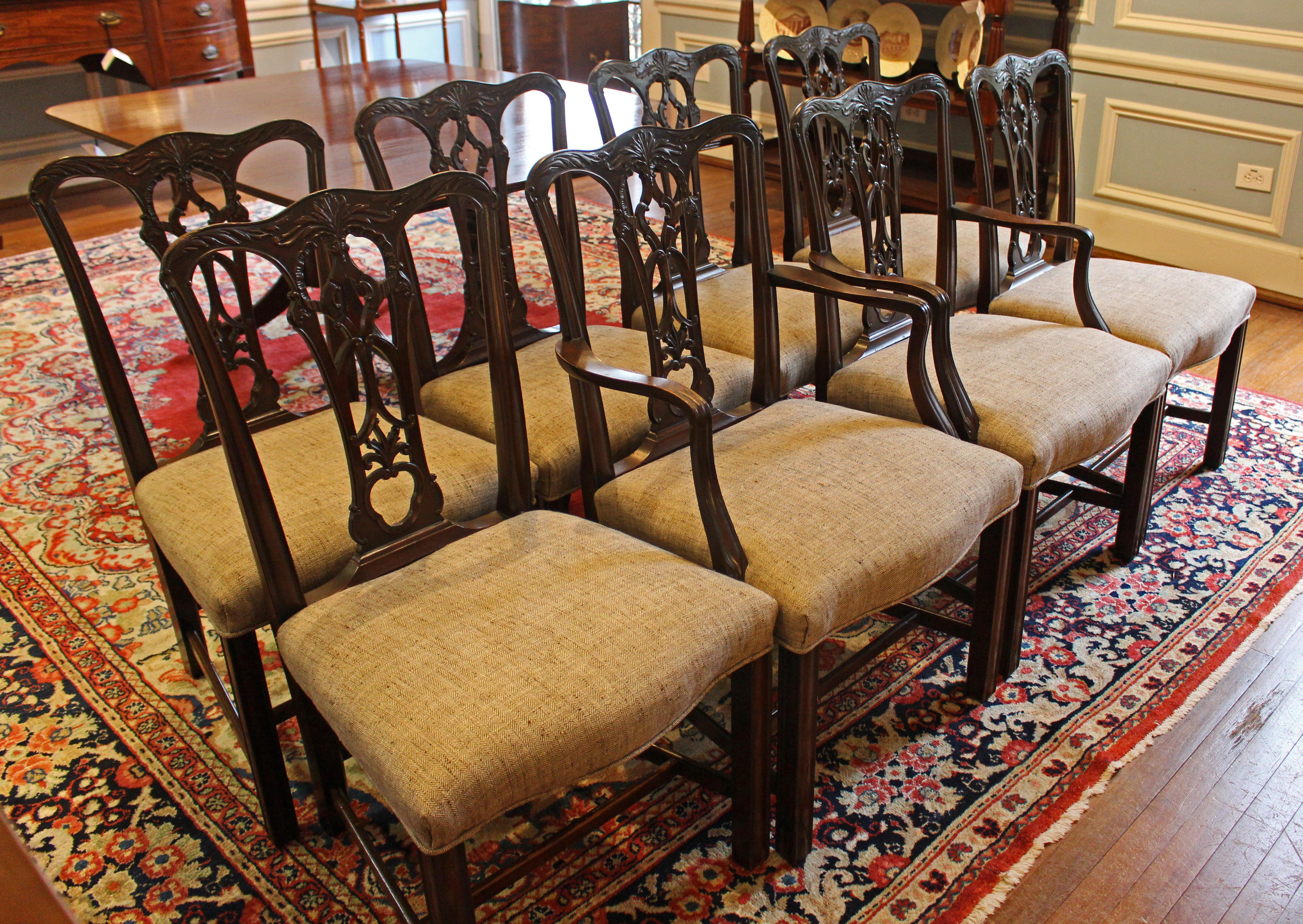 Mid-19th century set of 8 dining chairs in the resurging Chippendale Gothic taste of the time. 2 arms & 6 sides. Fine mahogany. Exceptionally well carved backsplats & crest rails with acanthus leaves and Gothic scrolls. Shaped, molded arms. Shaped