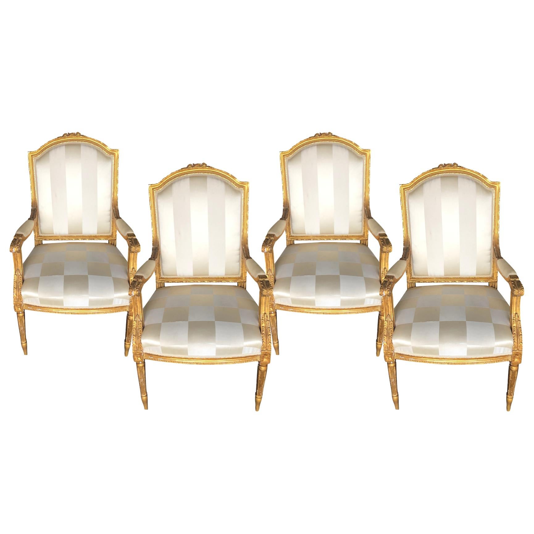 An antique French set of four very detailed carved and gilded armchairs from the 19th century in good condition, in the Louis XVI style. The upholstery is in used condition. Wear consistent with age and use, circa 1860, France.

Seat dimensions: