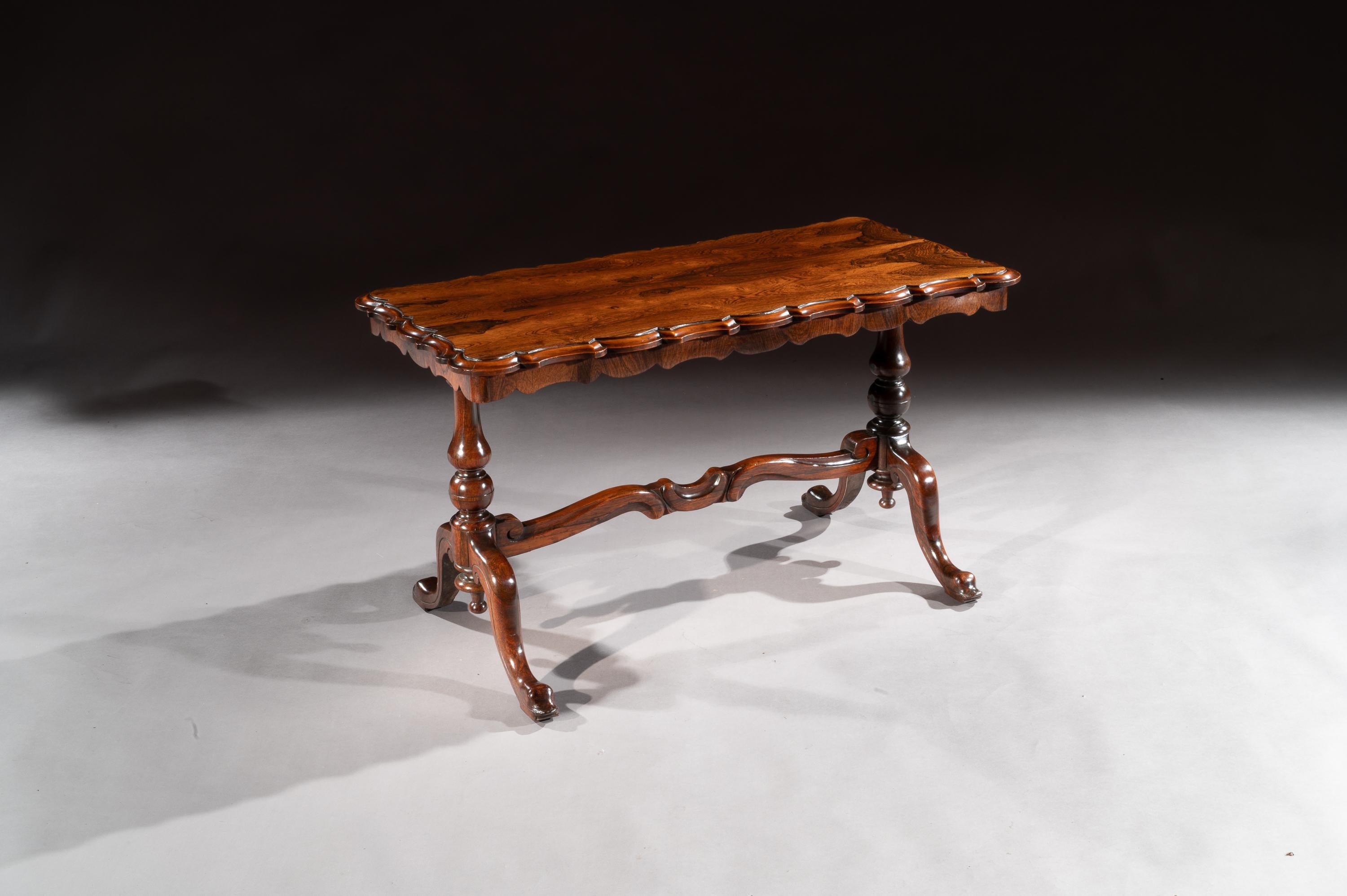 A good quality mid-19th century rectangular table which has been reduced in height to form a coffee table.

English, circa 1840 

Having a well chosen rosewood veneered rectangular top with a fine scalloped shaped edge supported by baluster end