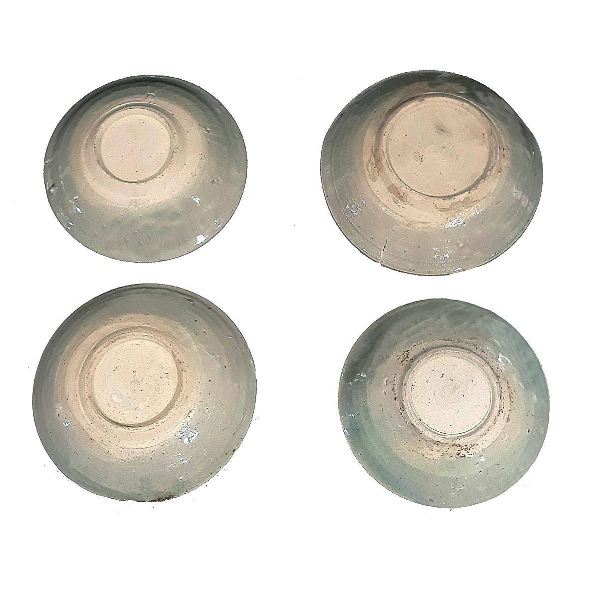 A set of four small ceramic plates / saucers, reclaimed from a mid-19th Century Indonesian shipwreck. 
Defying time and the elements, these plates were preserved at the bottom of the sea until the 1970s, when they were found and brought to the