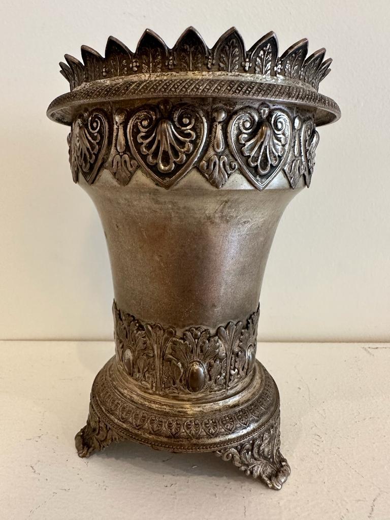 A silver vase rested on three stylized legs, decorate with two classical rings surrounding the lower and upper parts. What makes this vase unique however, is the mark that appears at its bottom and which designates the name of its Jewish owner S.