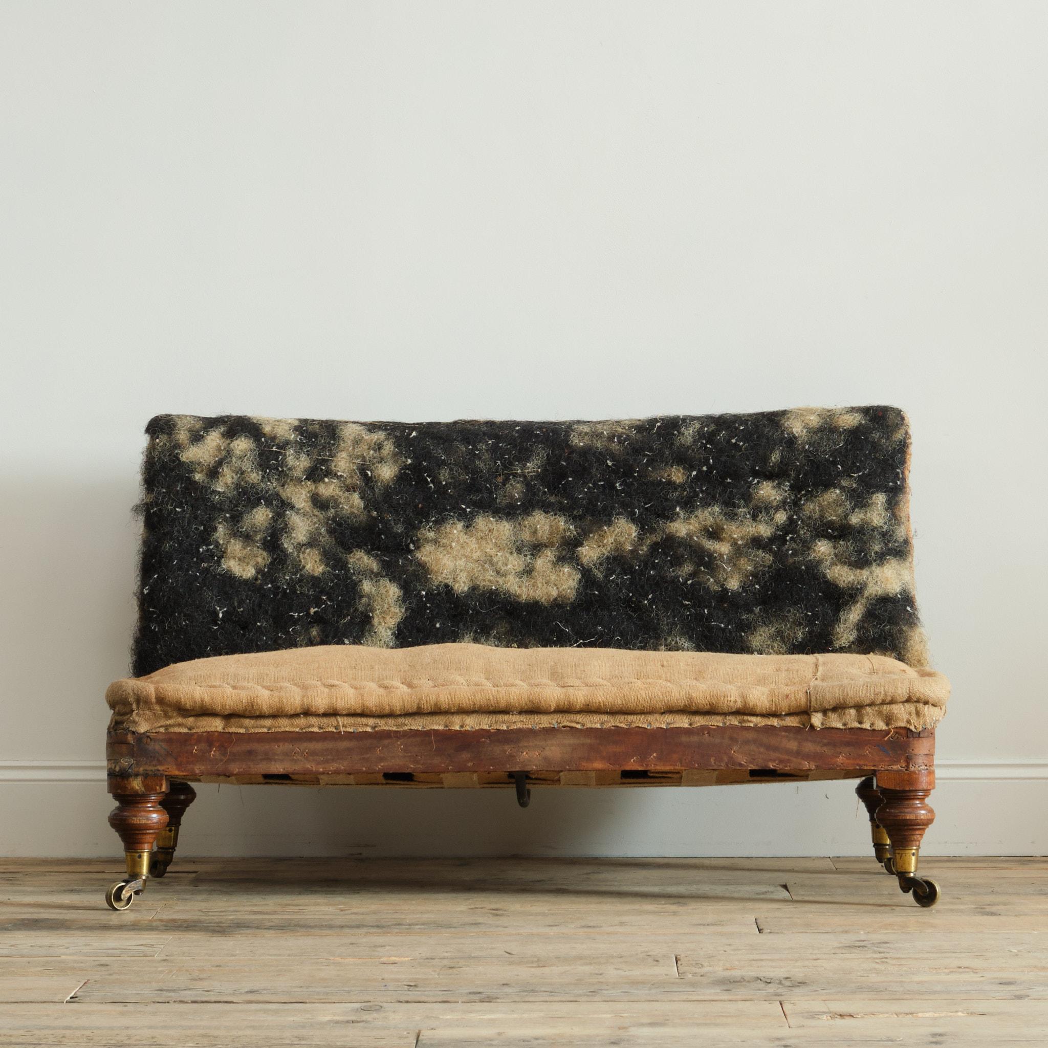 A good quality mid 19th century slipper sofa. Raised on on 4 turned walnut legs with the original Gilt brass Cope & Collinson casters. c1860

Retaining its original buttoned back upholstery.

Structurally in good solid order. 

As with all our