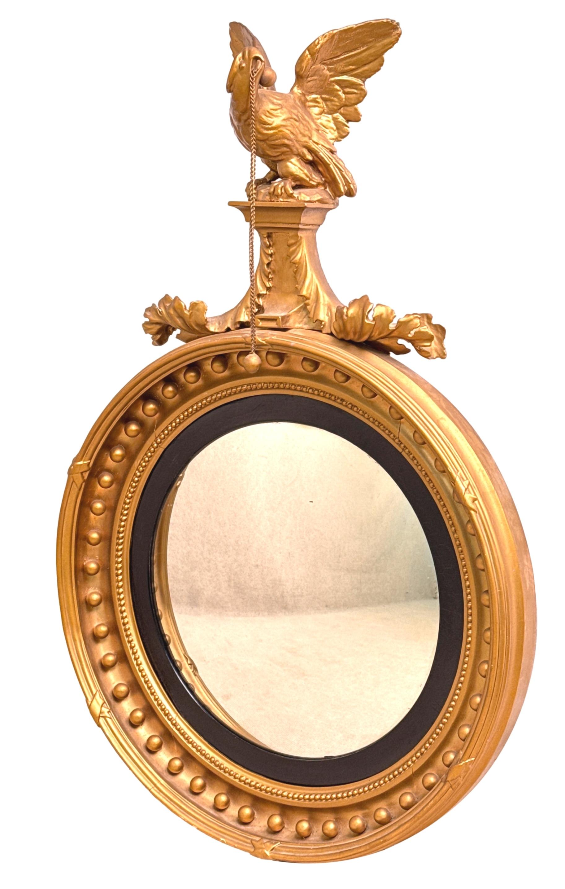 An Attractive Mid 19th Century Early Victorian Period Giltwood And Gesso Circular Convex Mirror, Of Relatively Small Proportions, Having Very Well Carved Eagle On Rocks Bearing Chain And Swept Foliage Surmount To Top, Over Typical Circular Frame