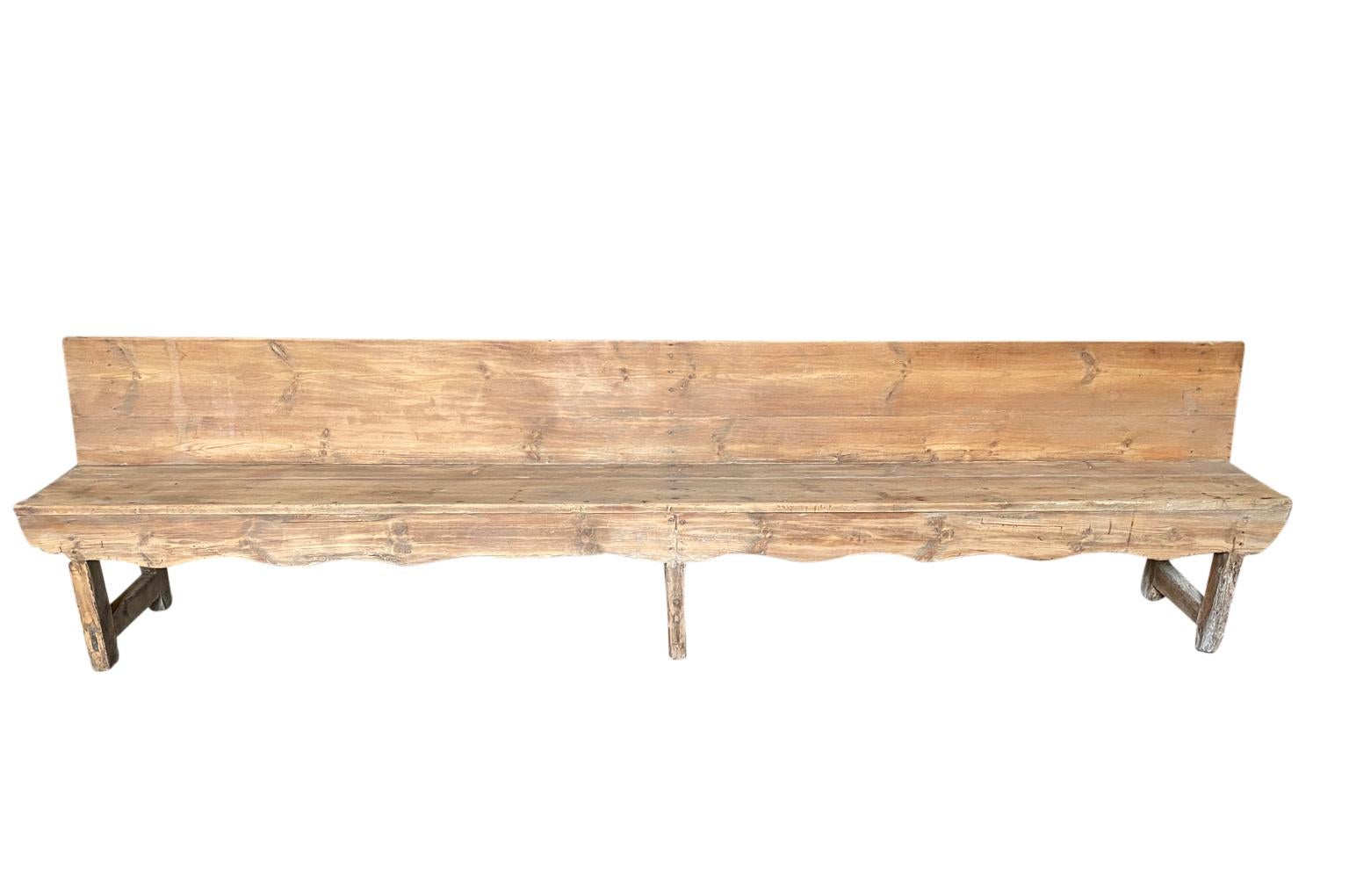 A very handsome and grand scale mid-19th century primitive bench from the Catalan region of Spain. Soundly constructed from Meleze - a very hard pine. The seat height is 19 1/4