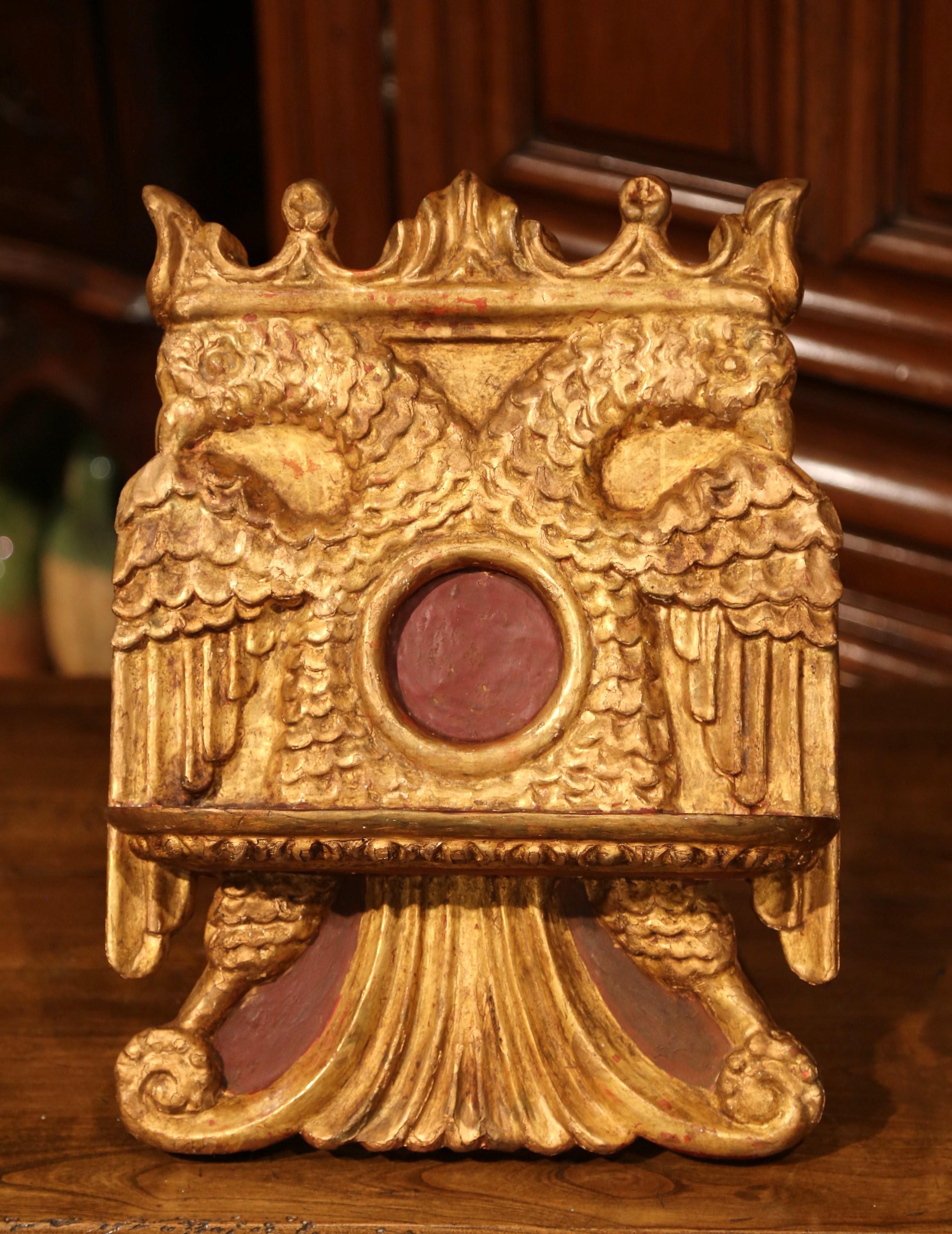 Place your Bible, music sheet or a recipe book on this antique, rococo book stand. Crafted in Spain, circa 1860, the decorative lectern sits on small tripod and features hand carved motifs on the front. The book stand is carved with a center