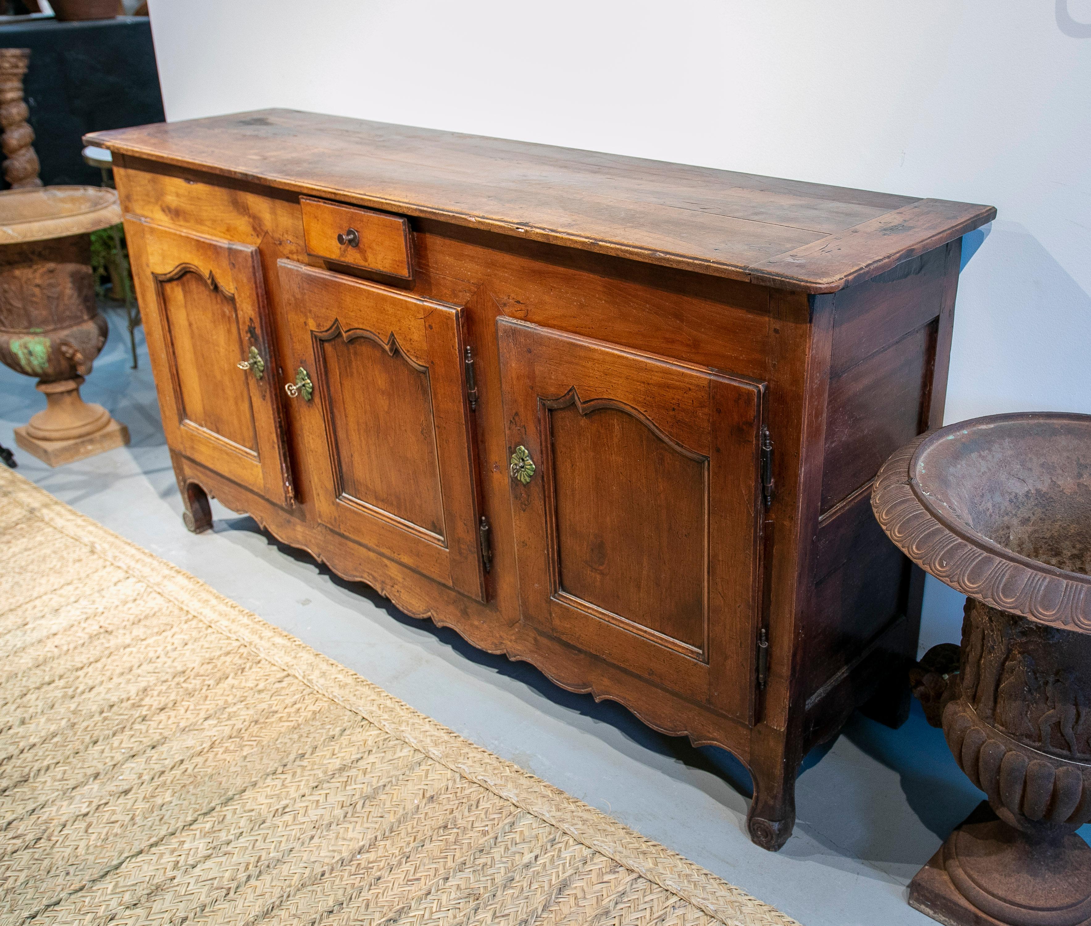 Antique mid-19th century Spanish wooden 1-drawer and 2-door farmhouse sideboard buffet table with bronze hardware.