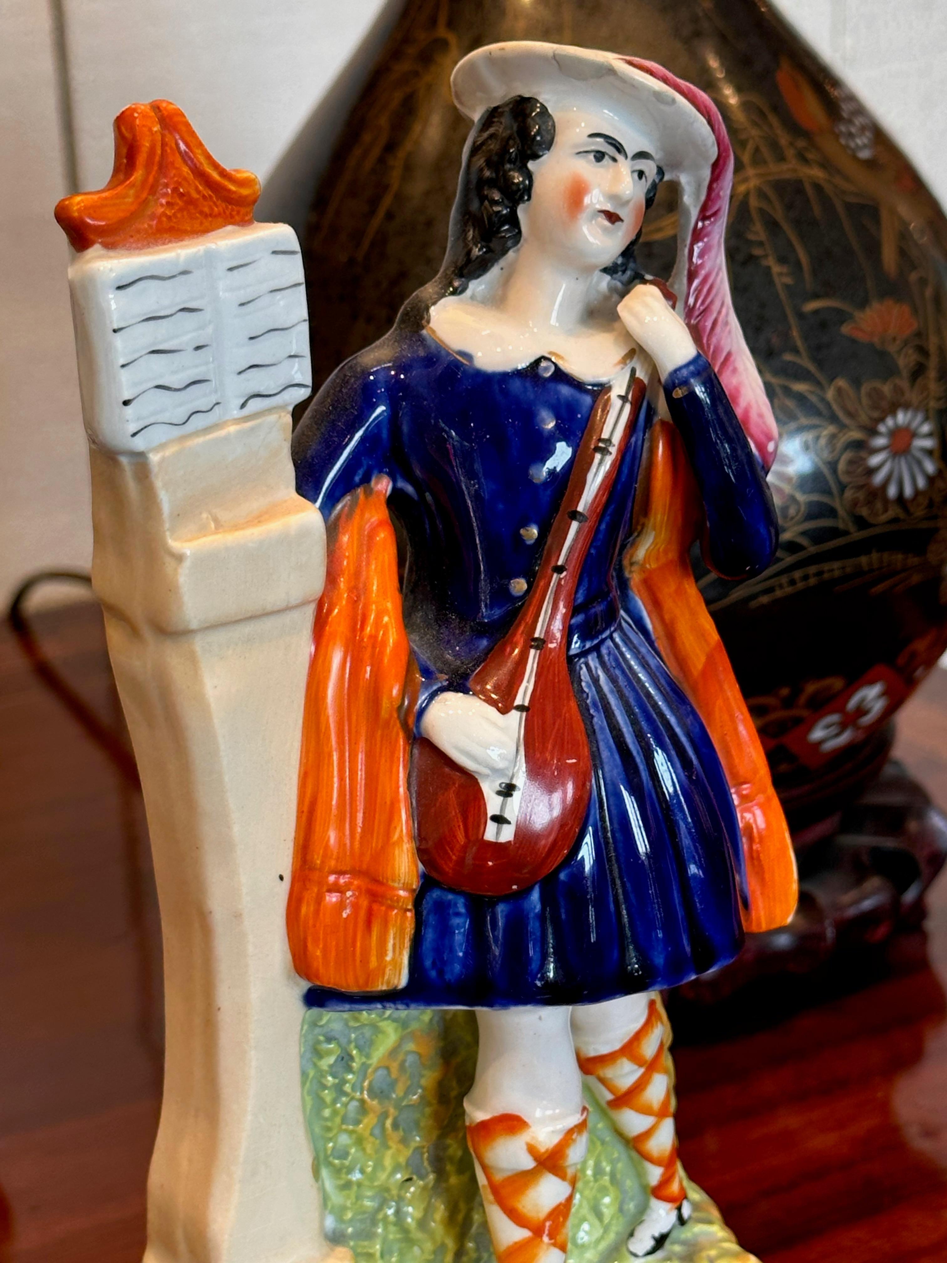 Nice color. A Scottish musician figurine. Made in the Mid 19th Century
