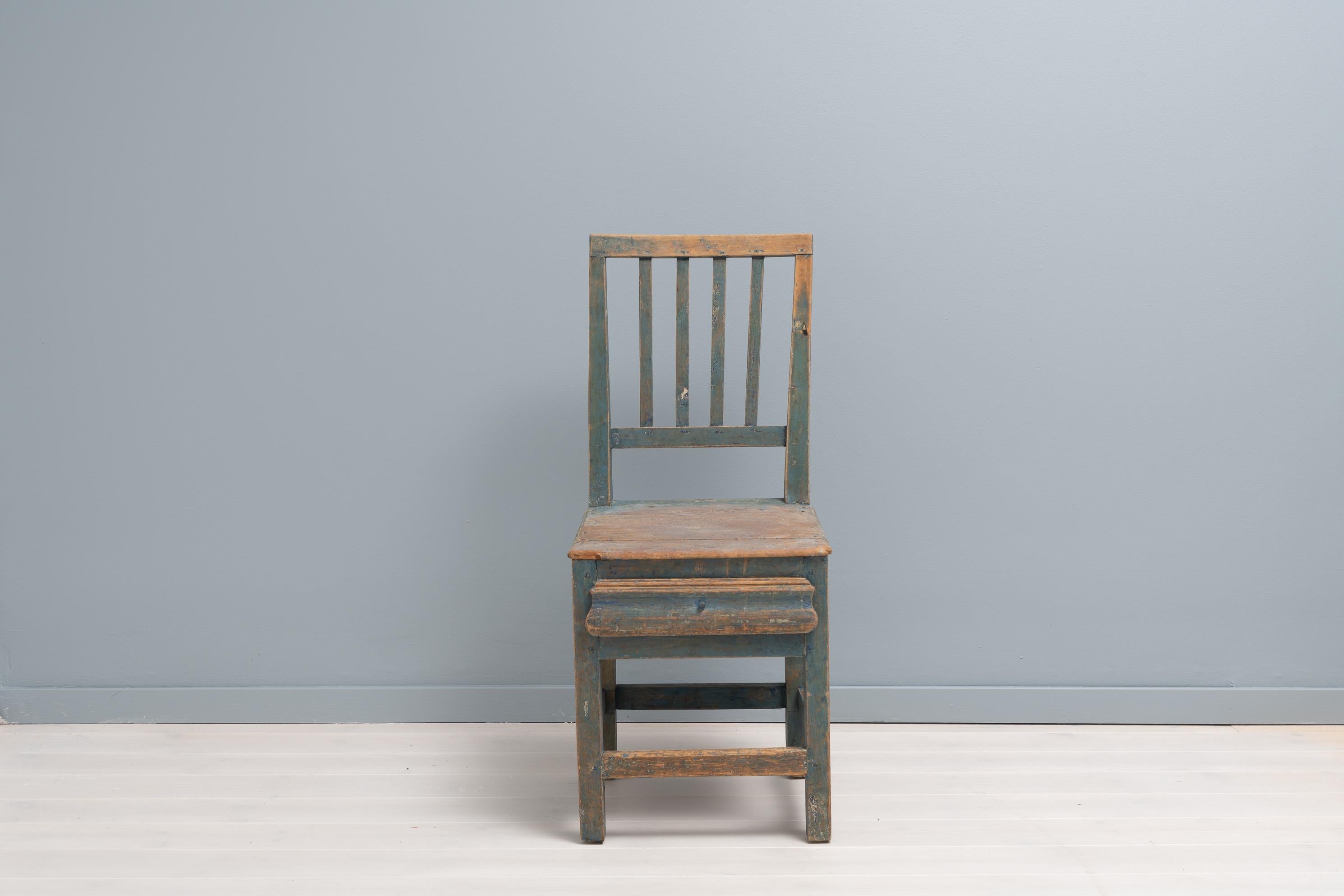 Blue Folk Art chair in Gustavian style from the mid 1800s. The chair is from Northern Sweden and has the original blue paint. The paint has some distress and patina so the wood underneath shines trough. The chair would work well as for example a