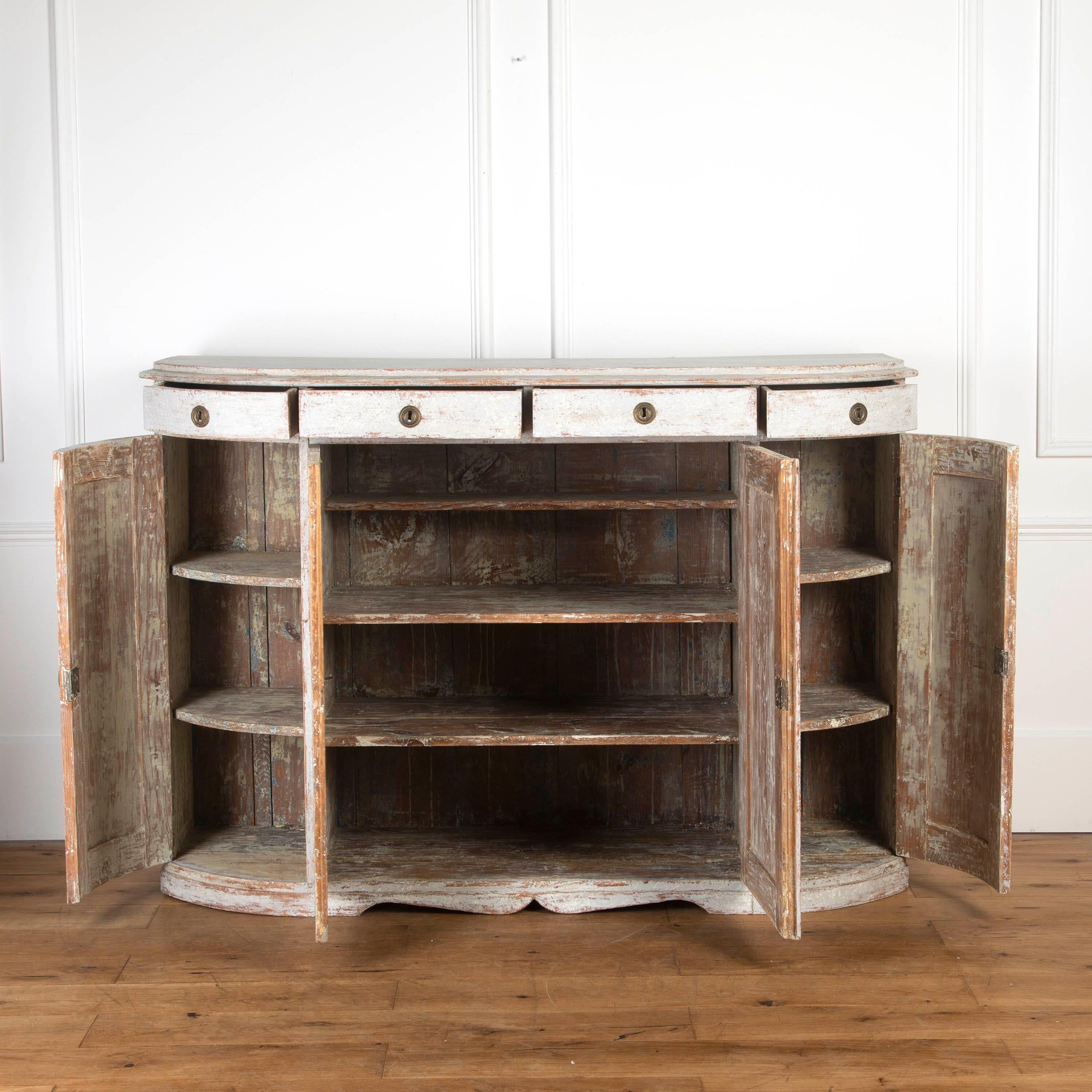 Beautiful mid 19th century Swedish buffet. 

This buffet has an elegant demi-lune form, with a moulded top and four drawers across the curved frieze. 

Below are four panelled cupboard doors which open to reveal a spacious interior with several