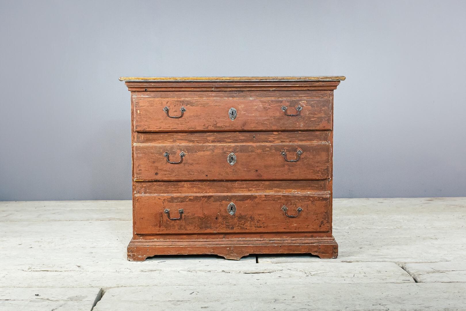 Swedish chest of drawers, the top surface with original naturally distressed painted faux marble finish, historical painted exterior. With original ironwork including carrying handles to either side.