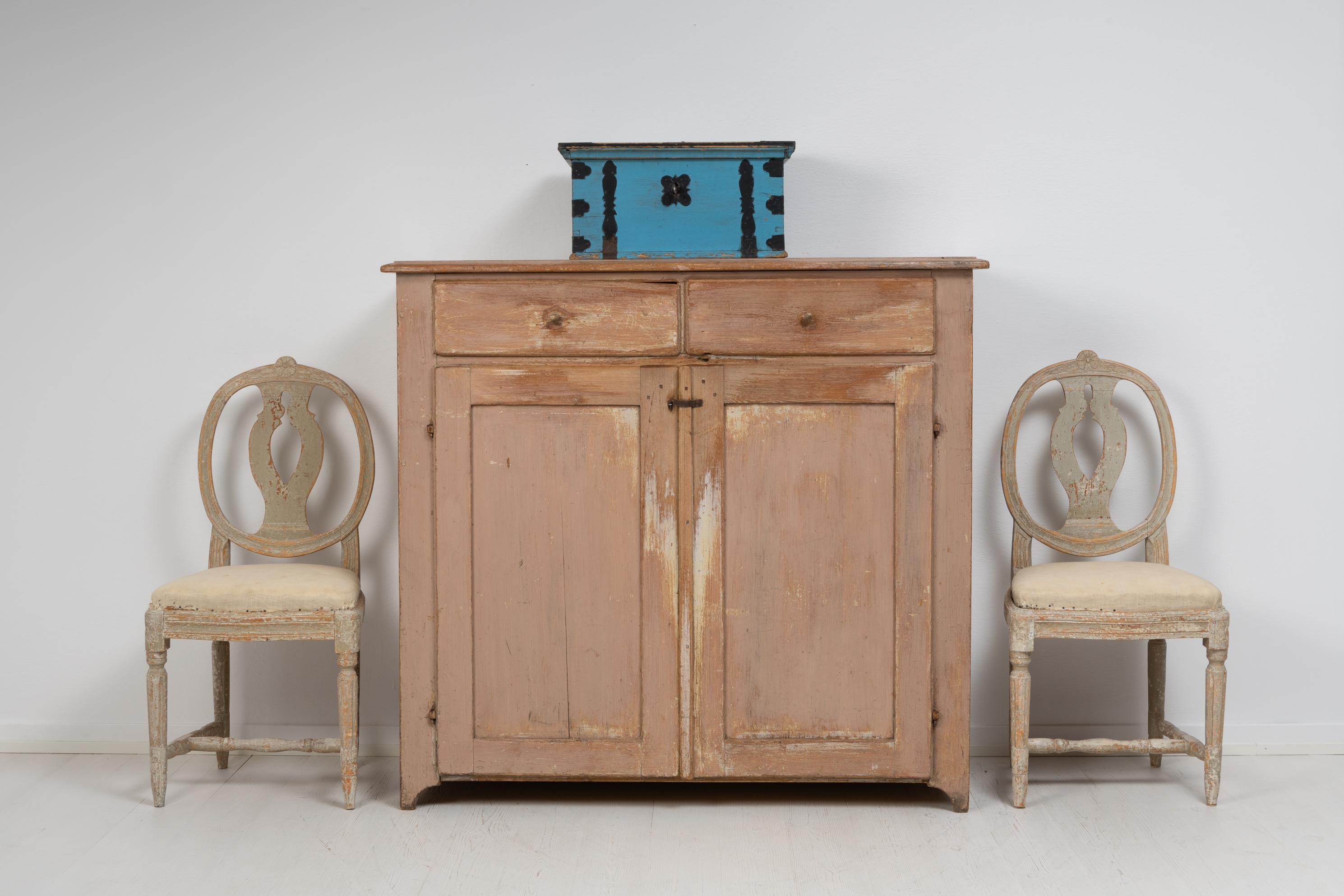 Country house sideboard from northern Sweden made around the mid 19th century, 1840 to 1850. The sideboard is folk art and has a straight shape with two doors and two drawers. A sideboard is one of the most recognisable country furniture from this