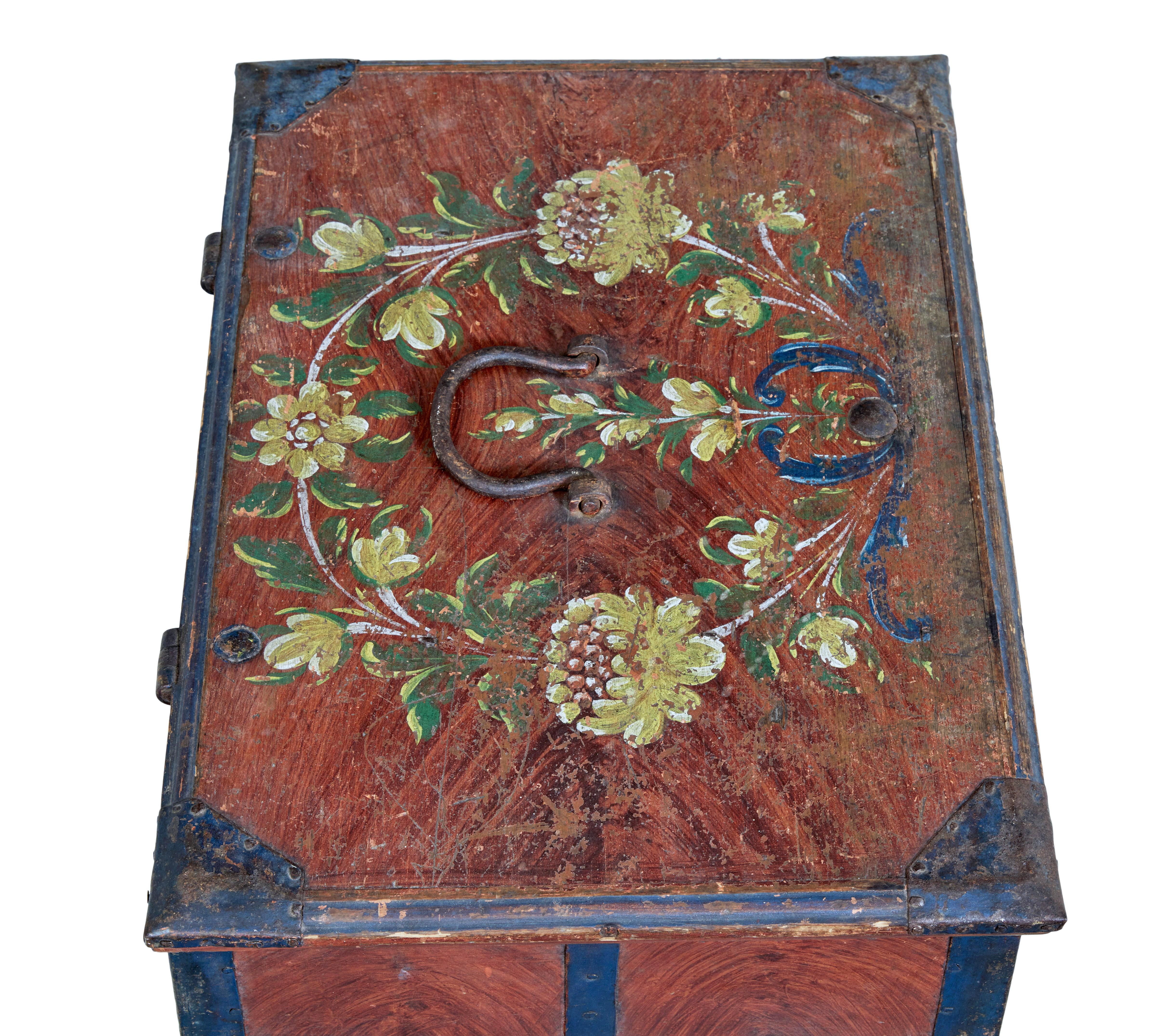 Mid 19th century Swedish folk art painted box circa 1865.

Good quality Swedish pine metal bound box.  Decorated with original ragwork paint and blue painted strap work.  Hand painted floral wreath to the lid, initialed and dated to the front,