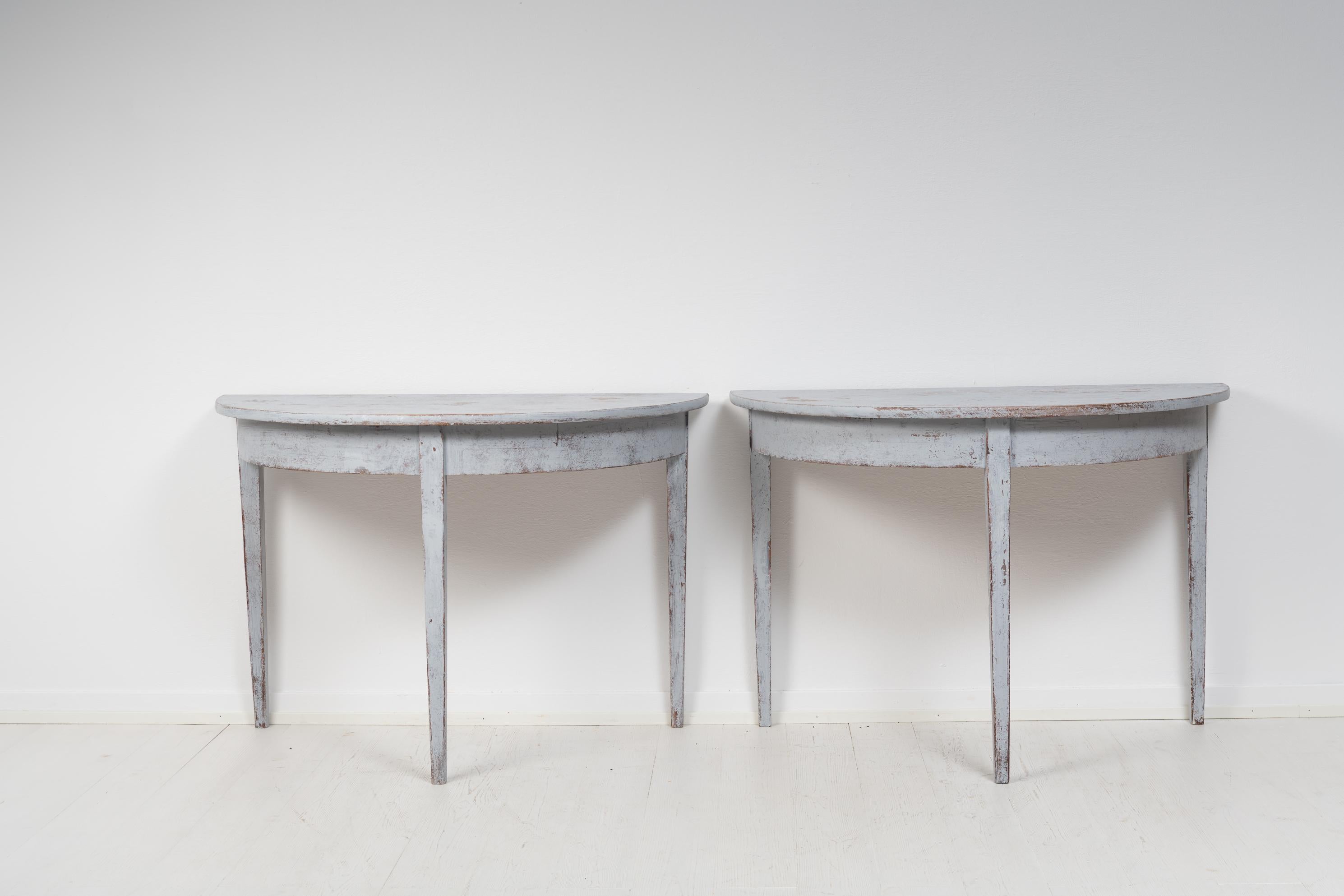 Swedish demi lune tables in gustavian style made around the mid 19th century, circa 1860. The table consists of 2 half-circles which can be used separately as console tables but also together as for example a dining table. The table has the straight