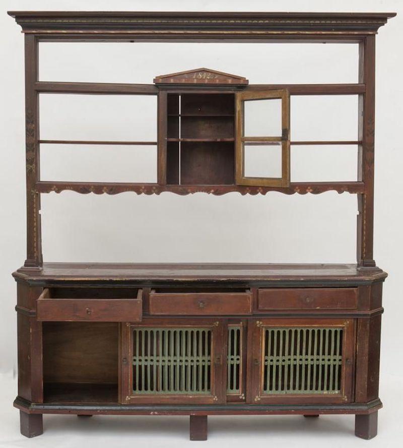 19th century Swedish kitchen cabinet with plate rack. Made of pine retaining the original painted decoration with floral details. The central cabinet dated “1842”. Unusual proportions with pieced painted sliding doors to the base. Sweden,