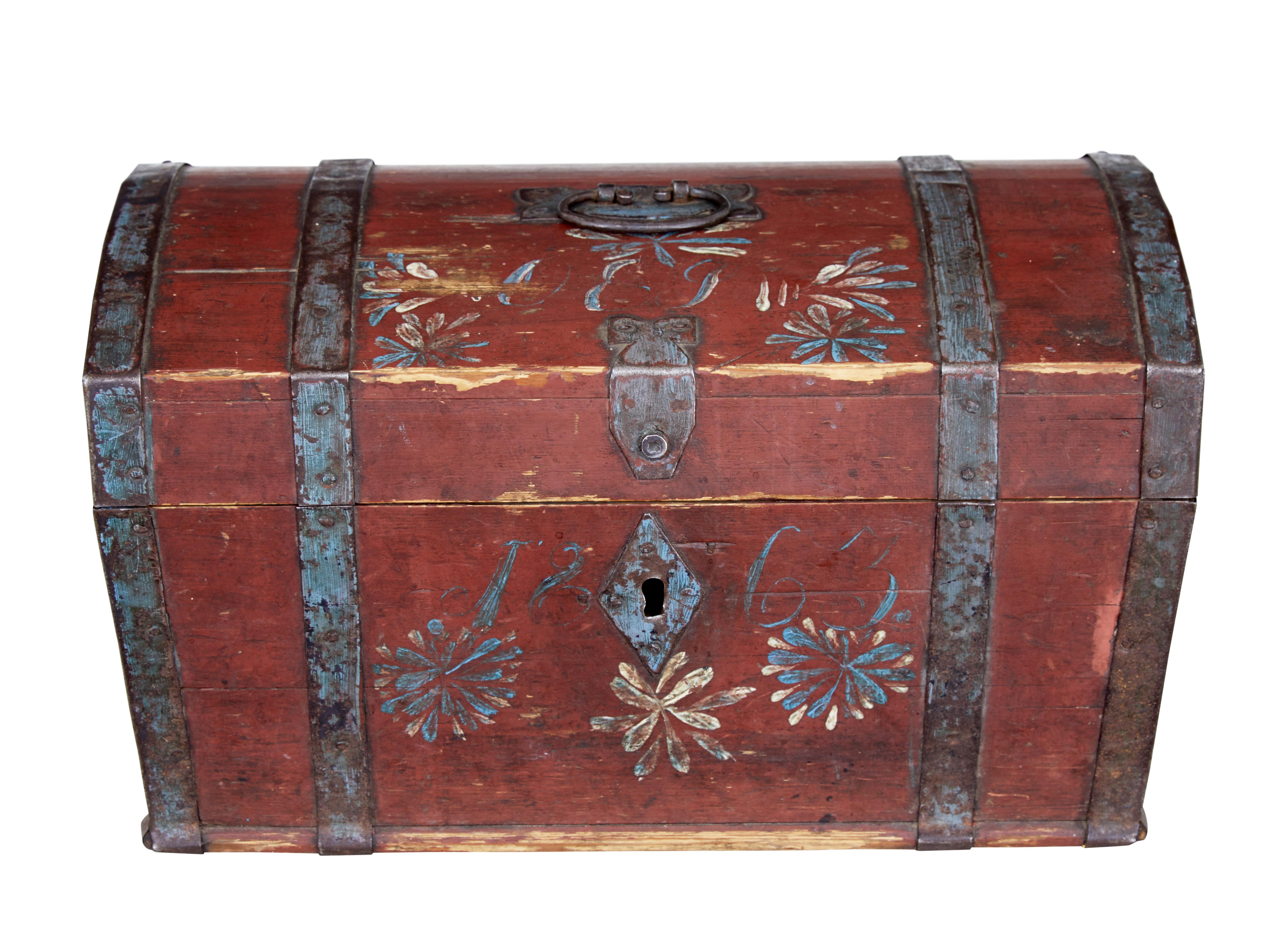 Mid-19th century Swedish pine painted box, circa 1863.

Beautifully little dome top strong box from the 19th century. Presented in its original red paint with decorative hand painted flowers, initials and date.

Metal bound, with handle on the