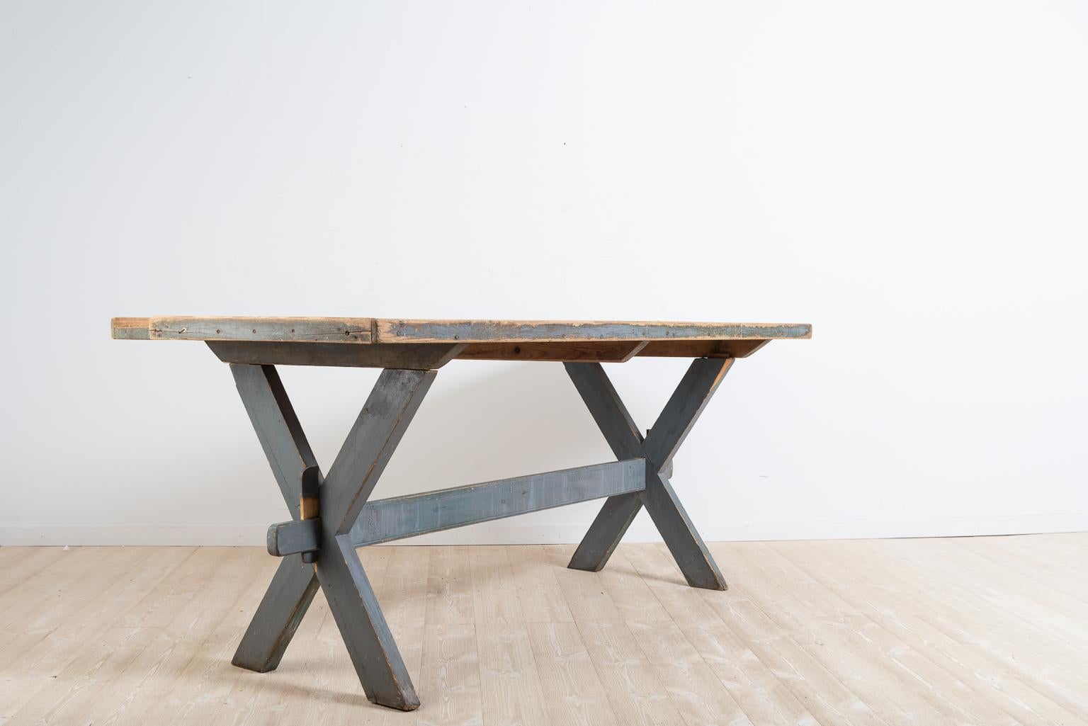Antique Swedish work or dining table from the mid-1800s. The table is in untouched original condition with a bare wood, never painted tabletop. The leg frame is painted with the original blue grey paint. Healthy solid frame with smaller loss of