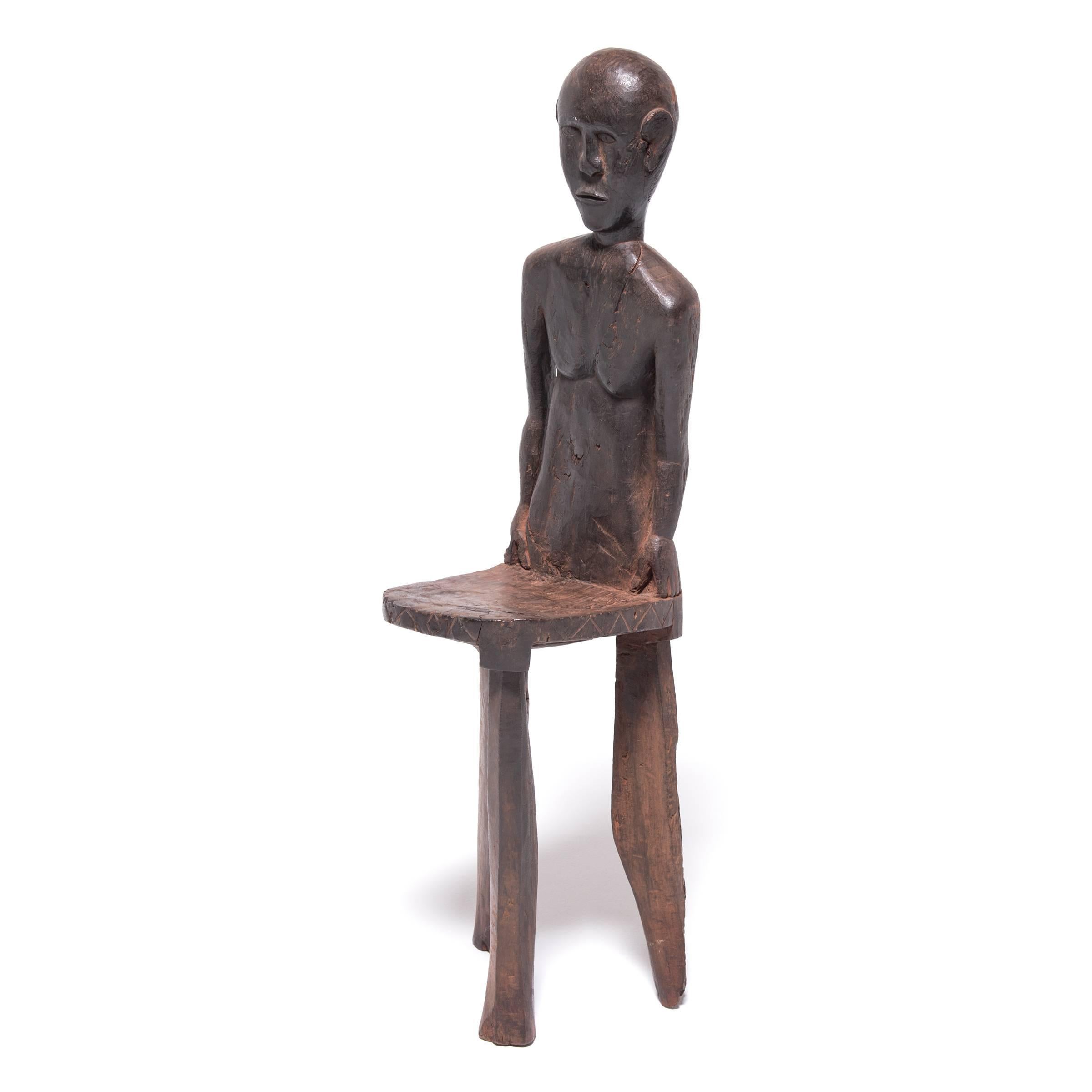 High-backed stools were reserved for tribal chieftains. This particular example features a backrest carved in the likeness of its owner, further attaching his status to his unique seat. This was most important during the judicial and initiation