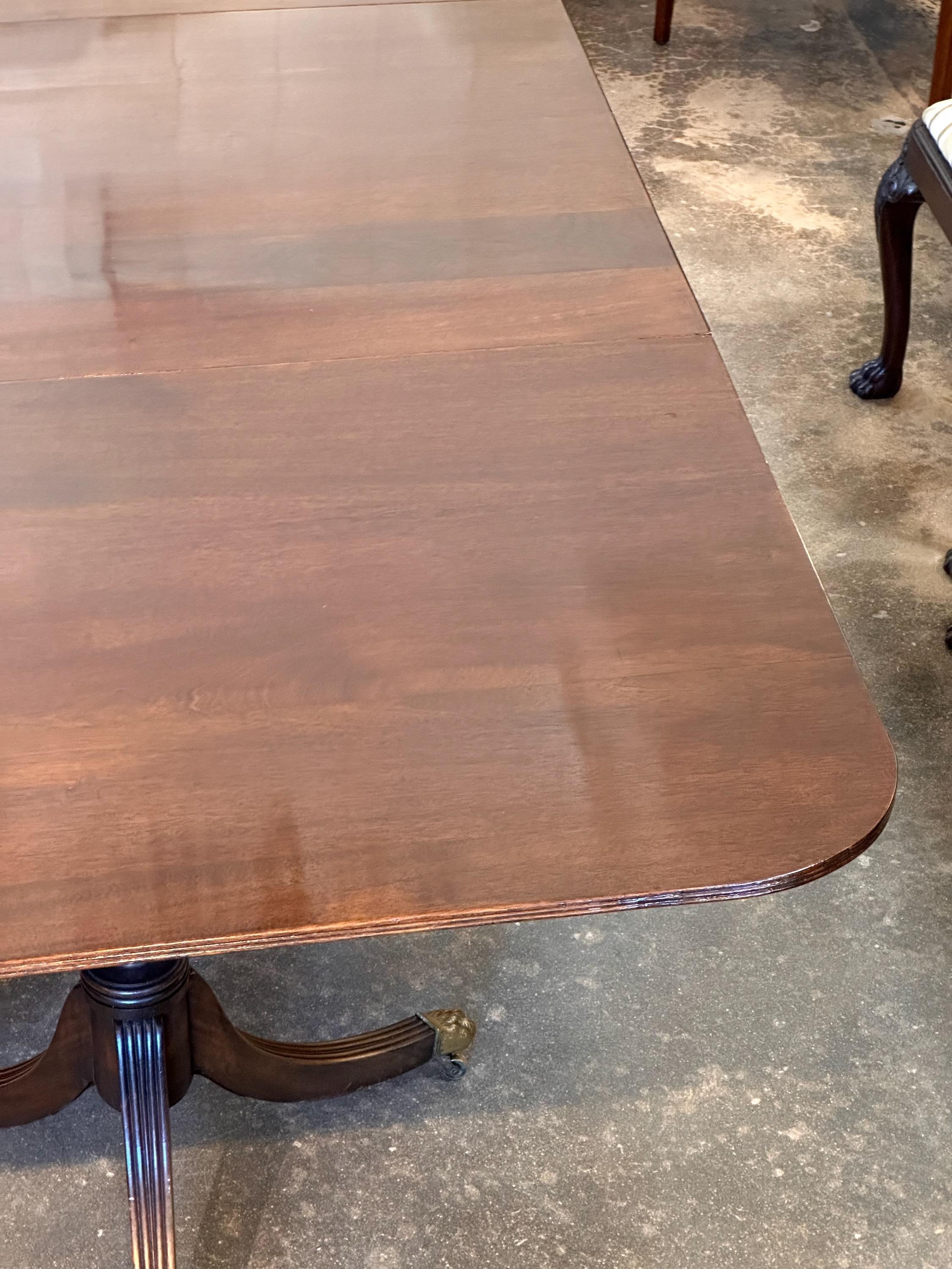 A handsome triple pedestal dining table. Beautiful mahogany .