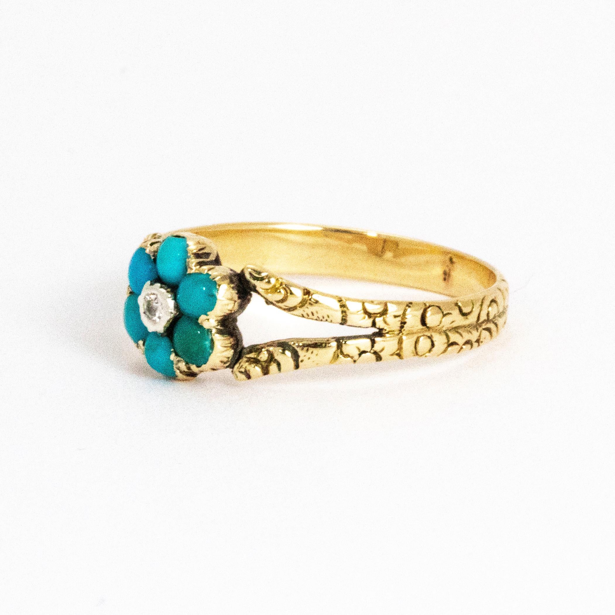 This delightful cluster ring holds six bright turquoise and in the middle sits a shimmering diamond. The ring is modelled out of 15ct gold and is beautifully engraved all the way around the band.

Ring Size: N or 6 3/4